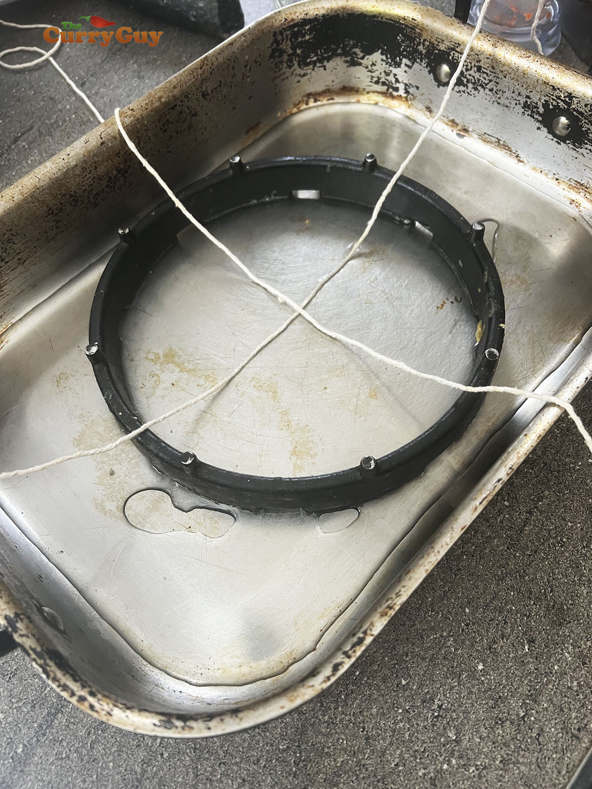 Preparing the string for tying the banana leaves around the meat. 
