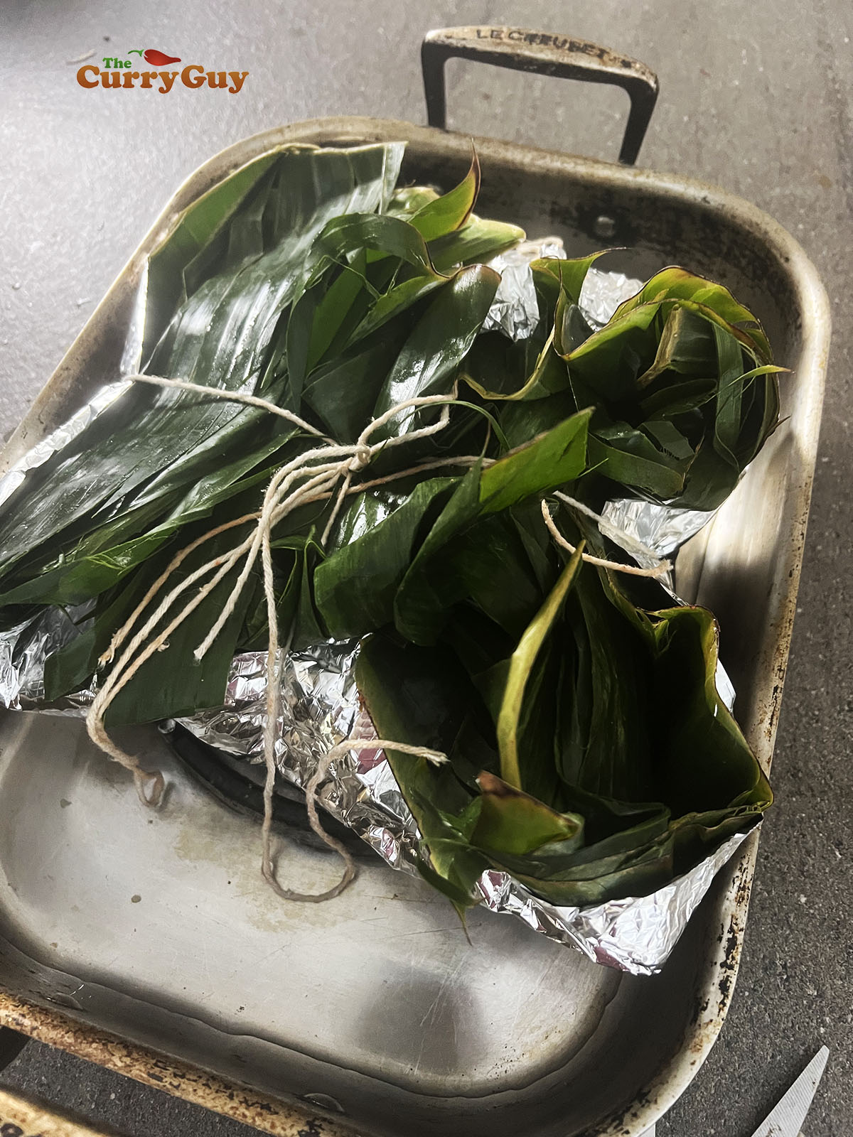 Pork wrapped in banana leaves.