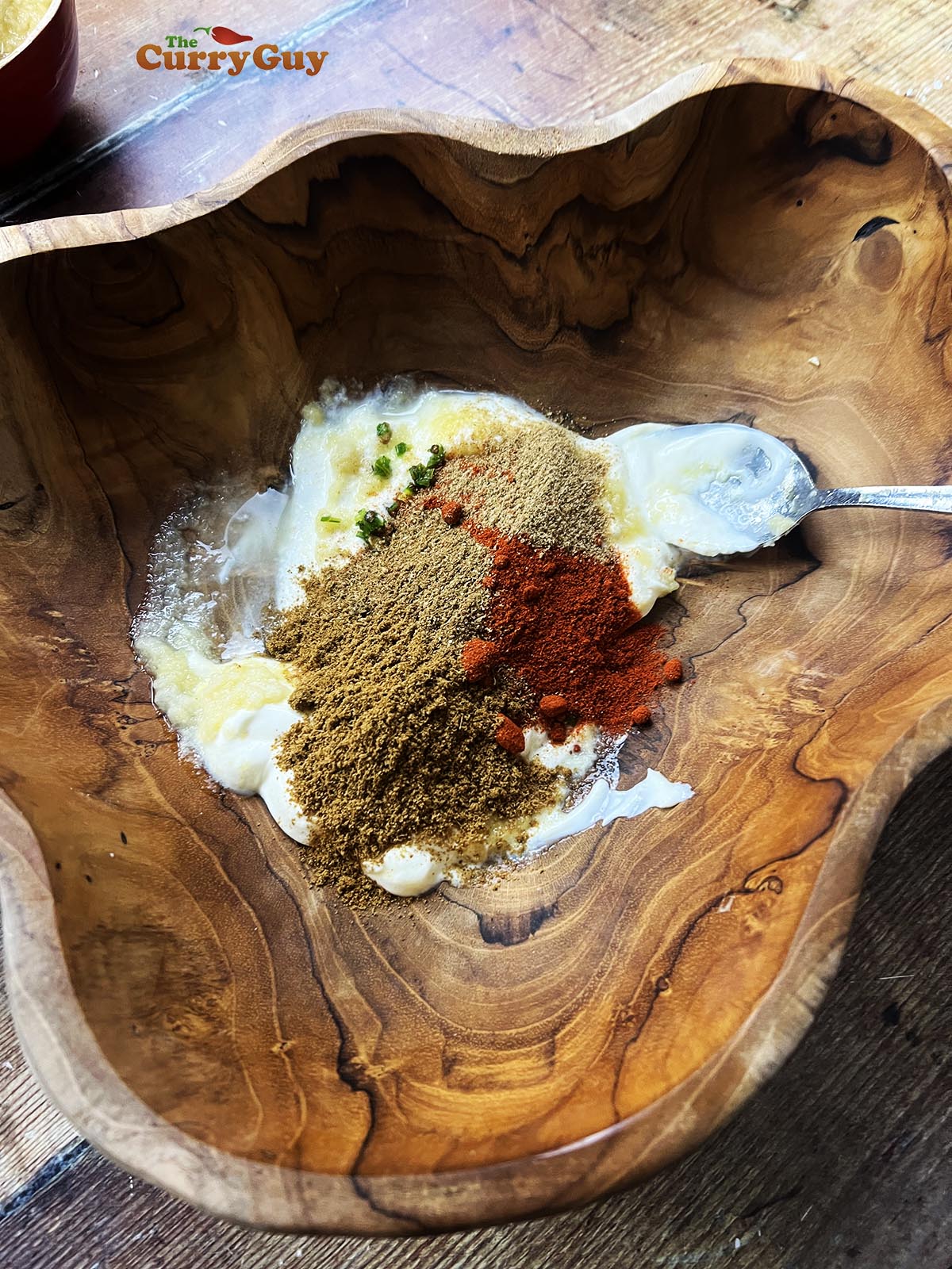 Mixing yoghurt marinade ingredients.