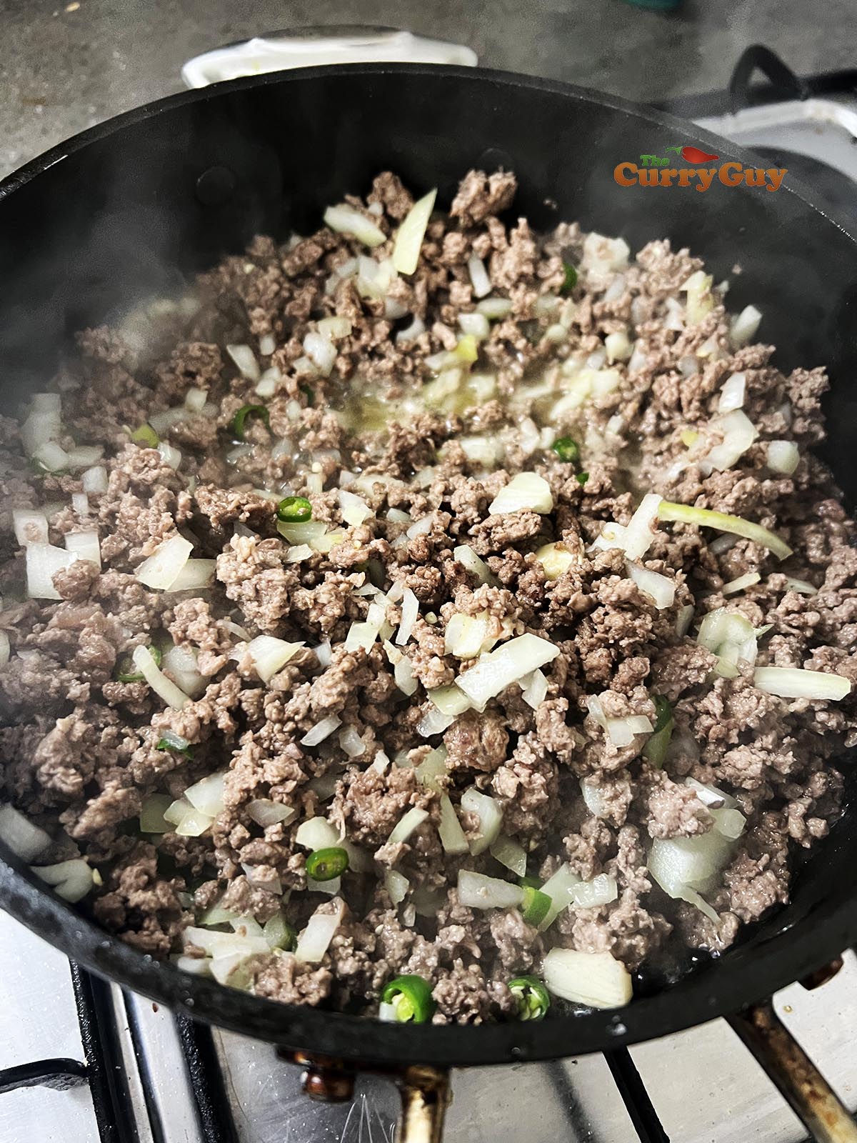 Onion and chilies added to the pan.