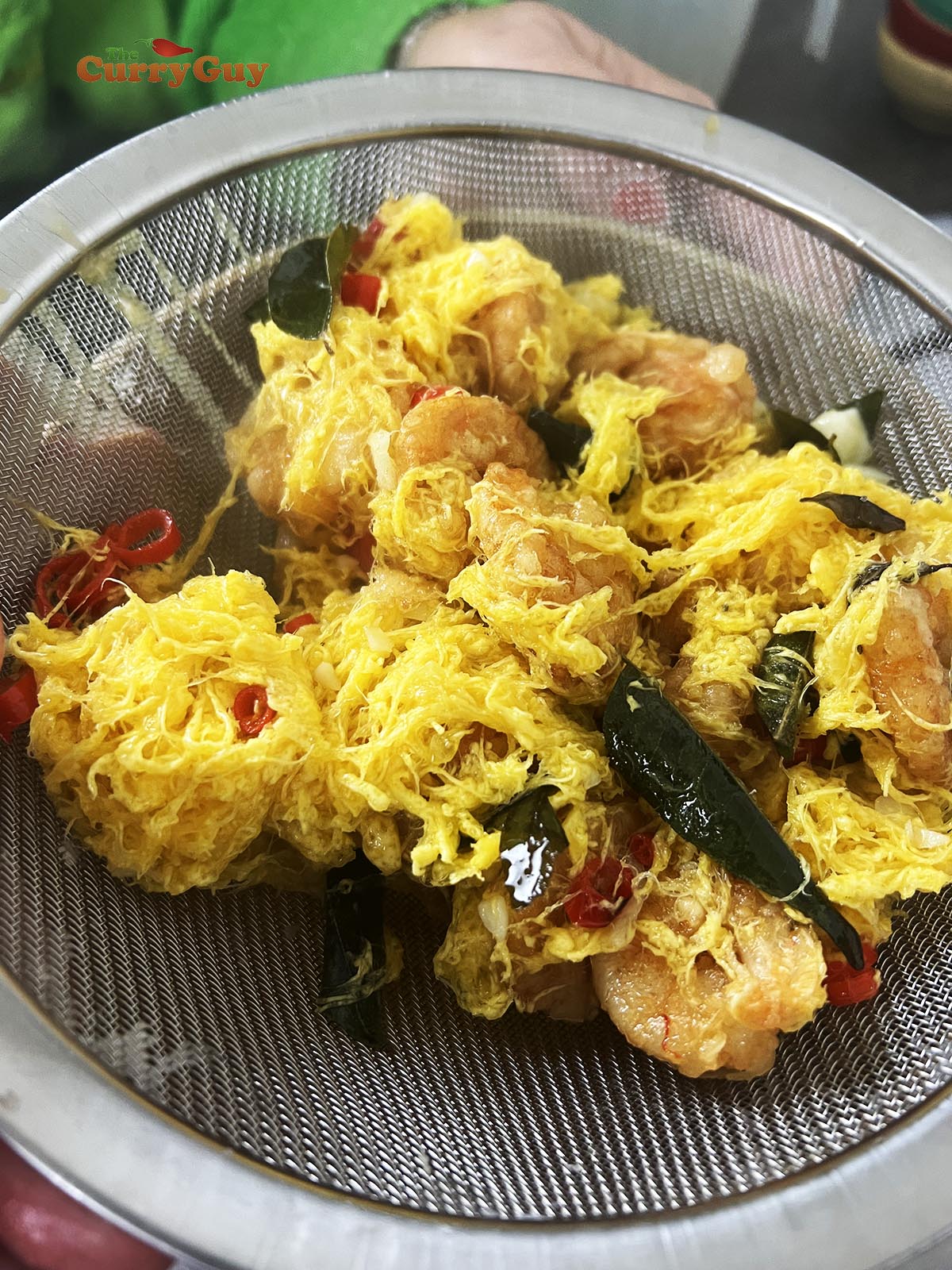 Running the butter mixture through a fine sieve.
