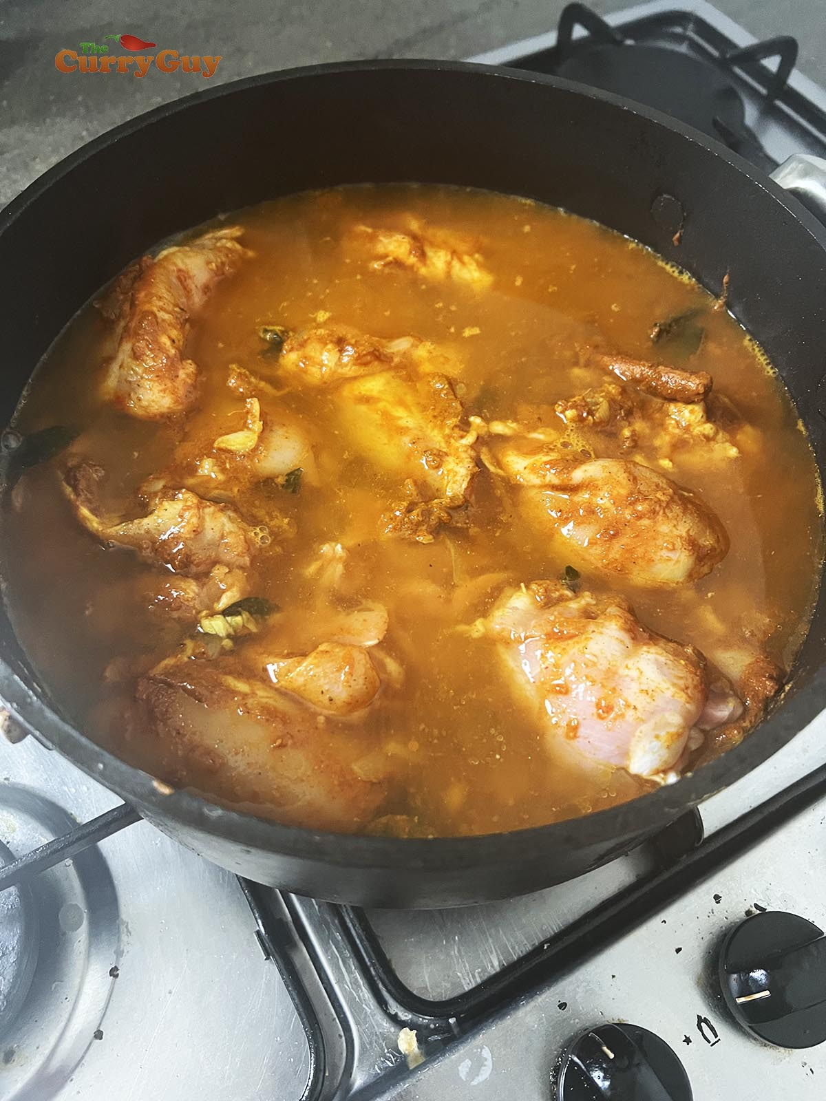 Adding water to the pan which will make the sauce.