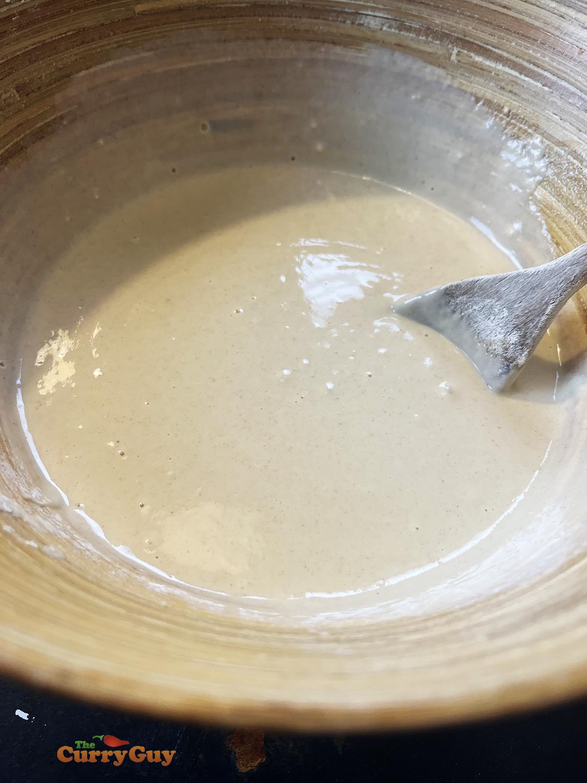 Adding water to the flour and egg to make a 