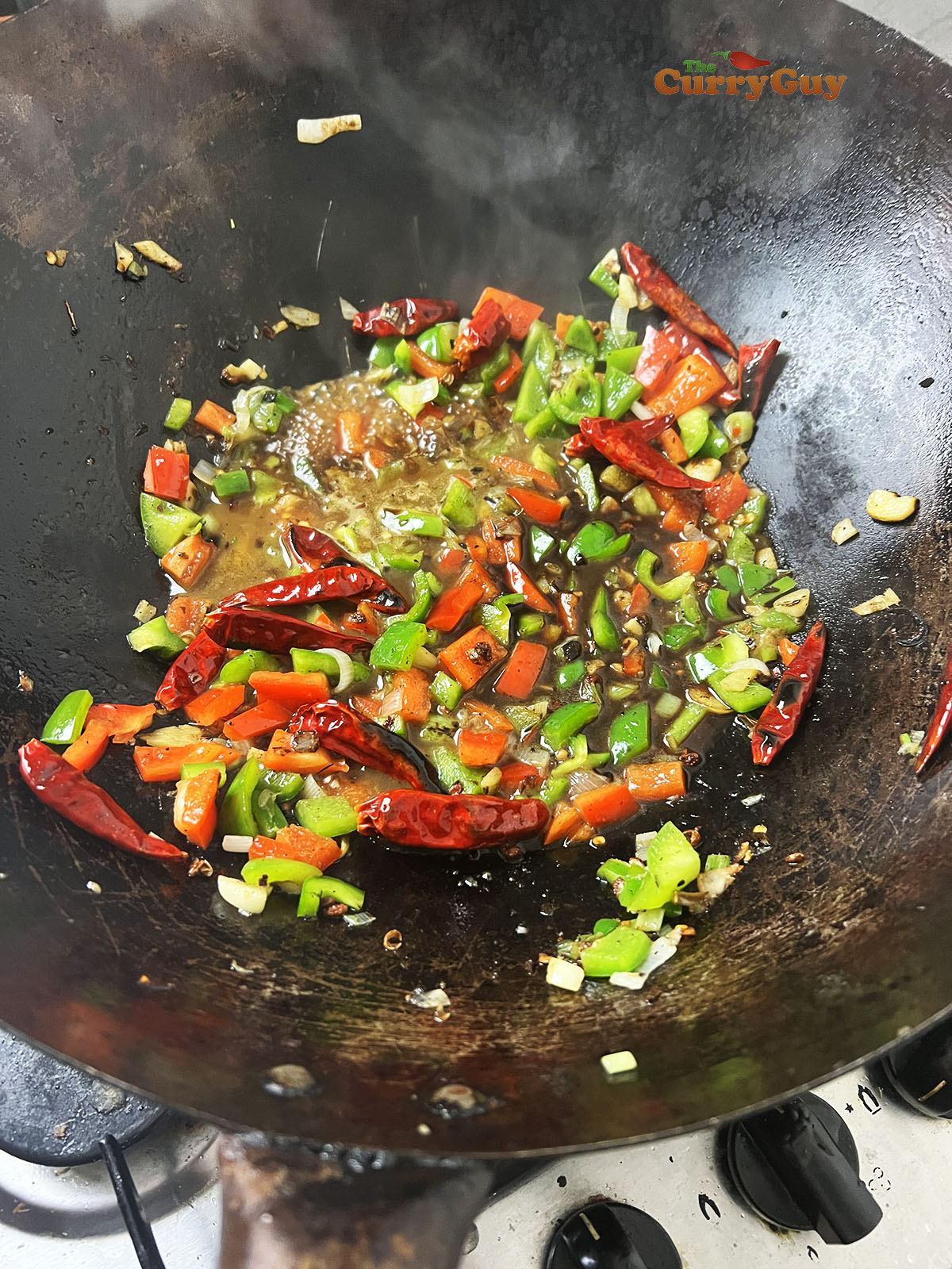 Bring the prepared sauce to a simmer in the wok.