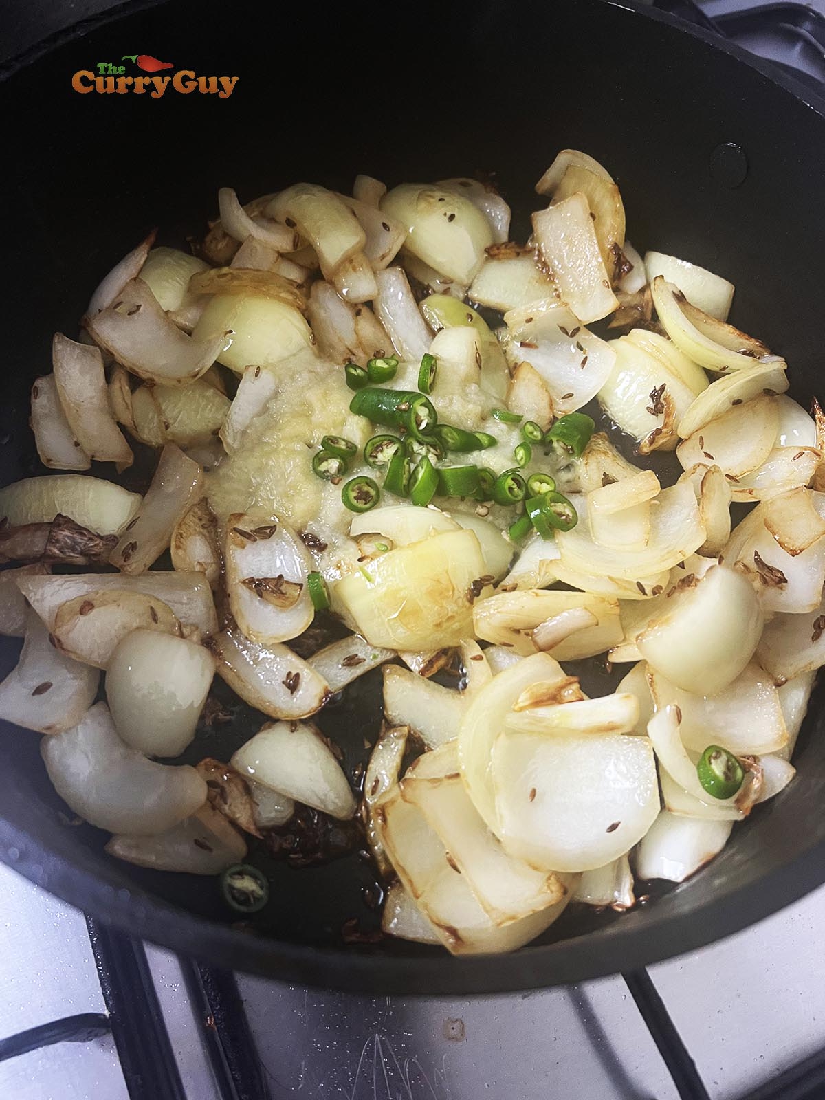 Adding onions, chillies and garlic and ginger