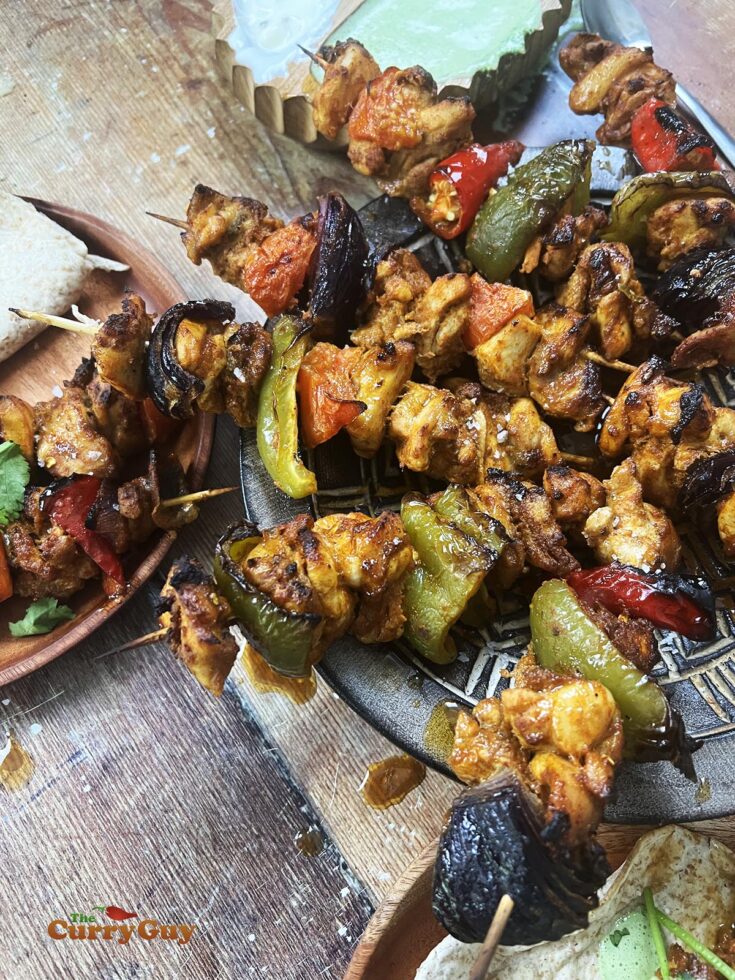 Sheet pan chicken tikka with vegetables and chapattis.