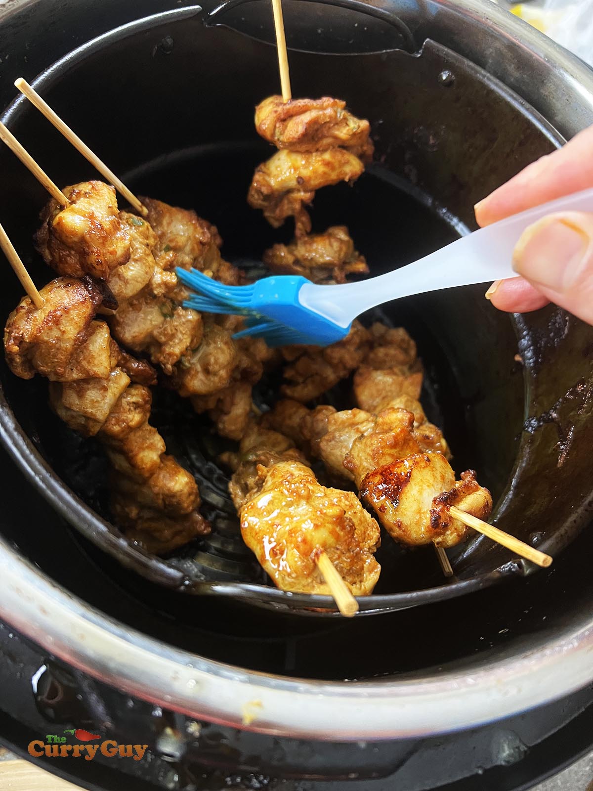 Basting the chicken with butter.