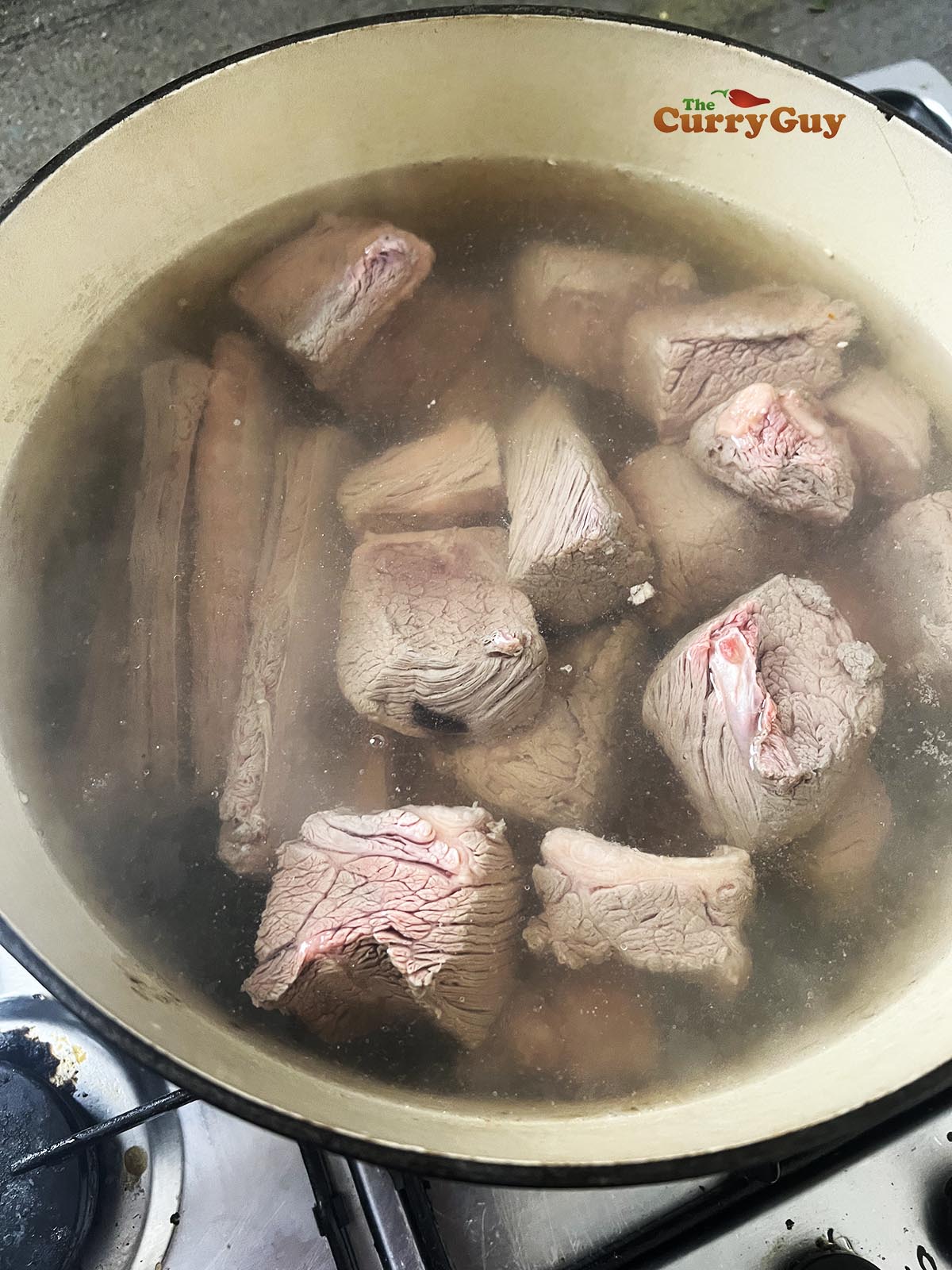Beef and beef bones simmering in water
