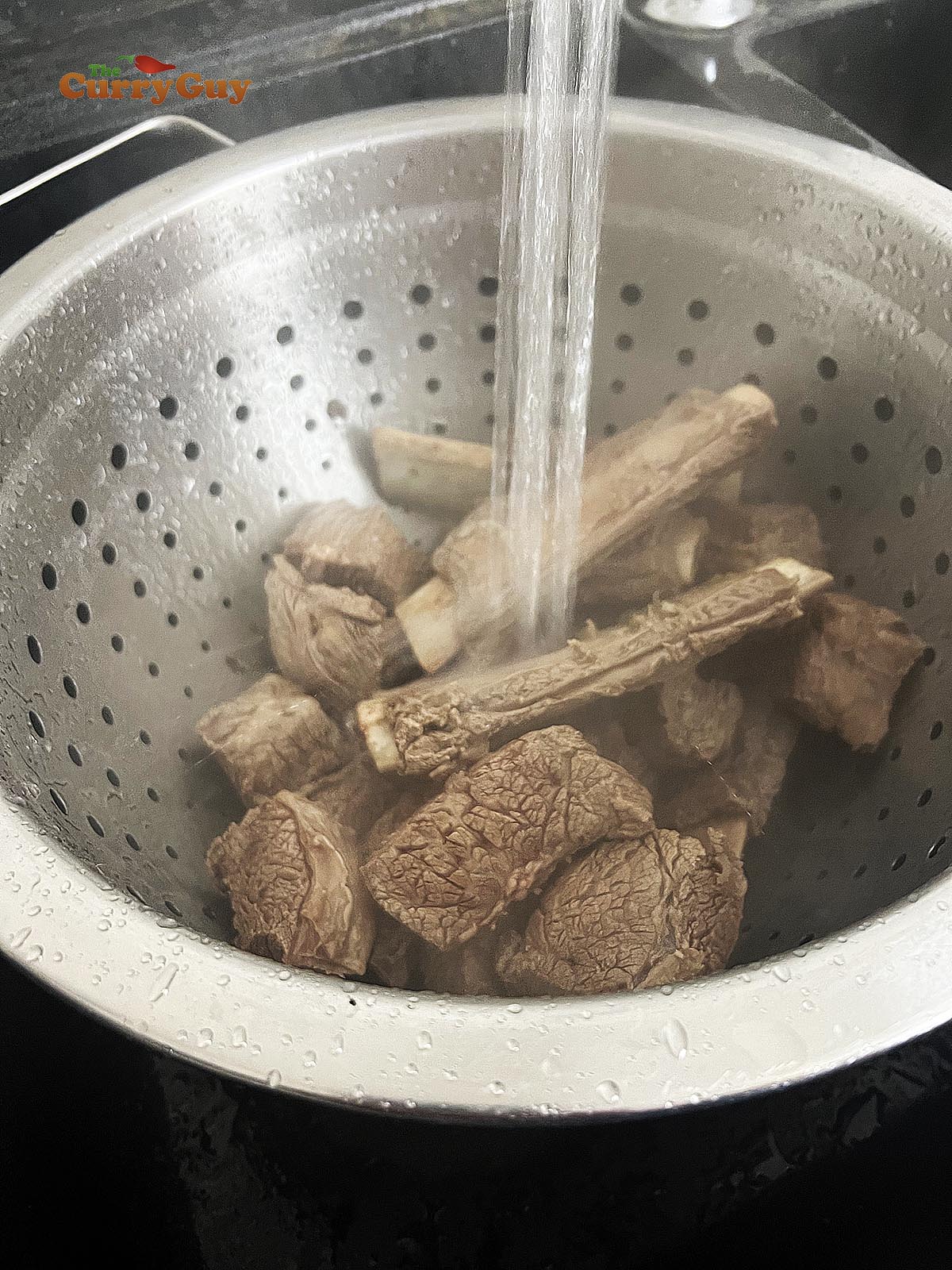 Straining and washing the beef and beef bones