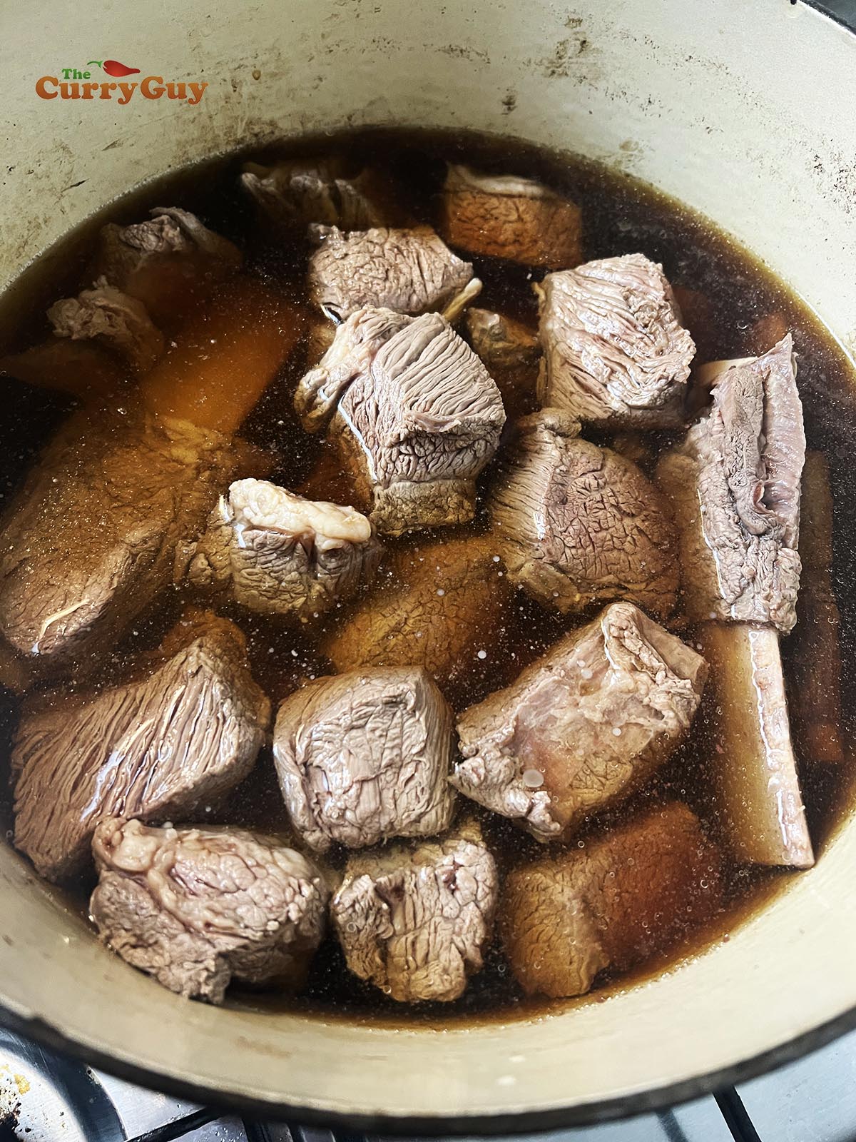 Beef back in the pot covered with water, honey, soy sauce and Chinese rice wine.