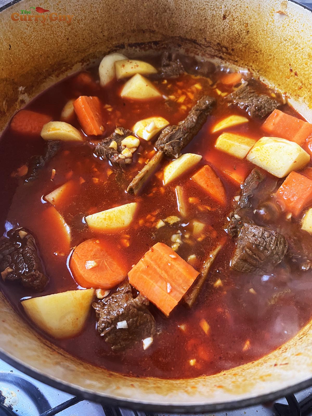Adding potatoes and carrots.