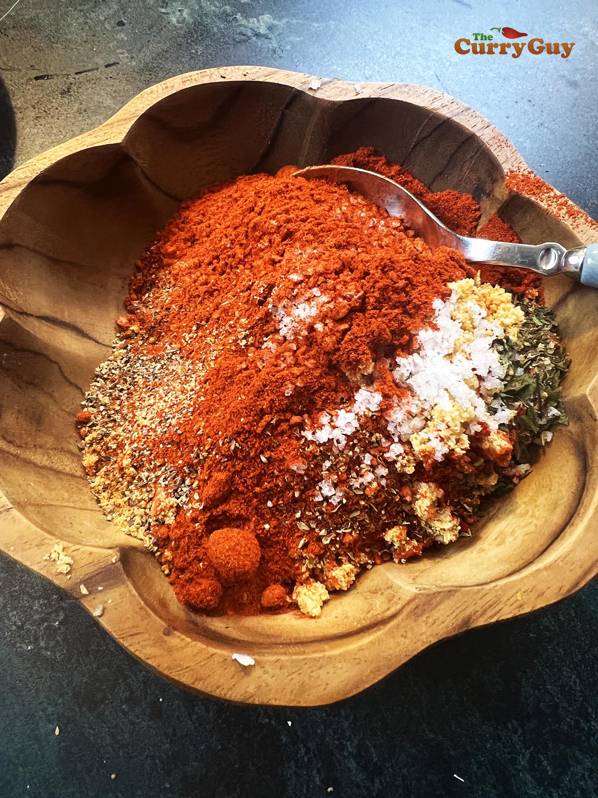 Ingredients for this Cajun seasoning recipe in a mixing bowl.