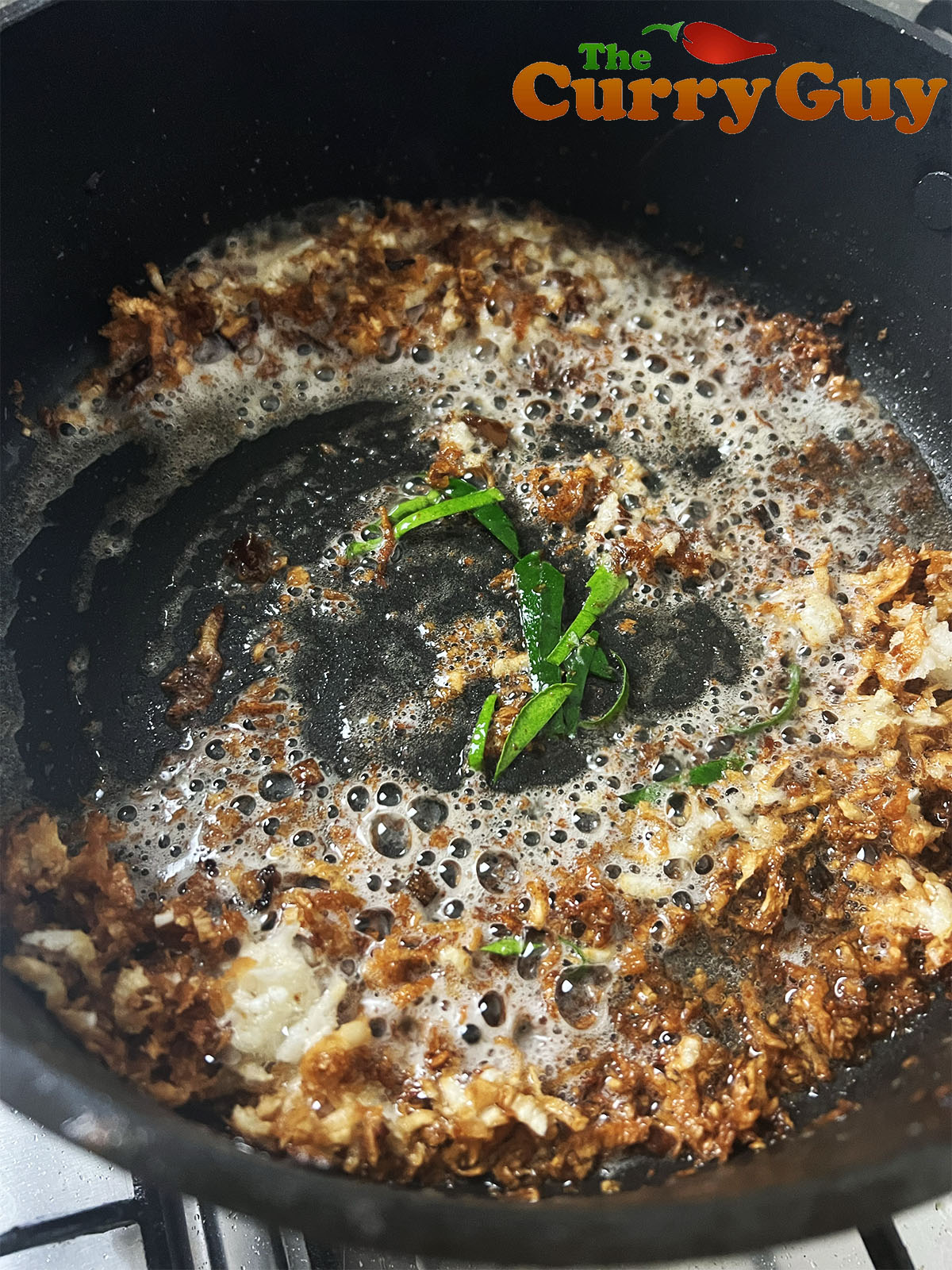 Adding the shrimp paste and lime leaves.