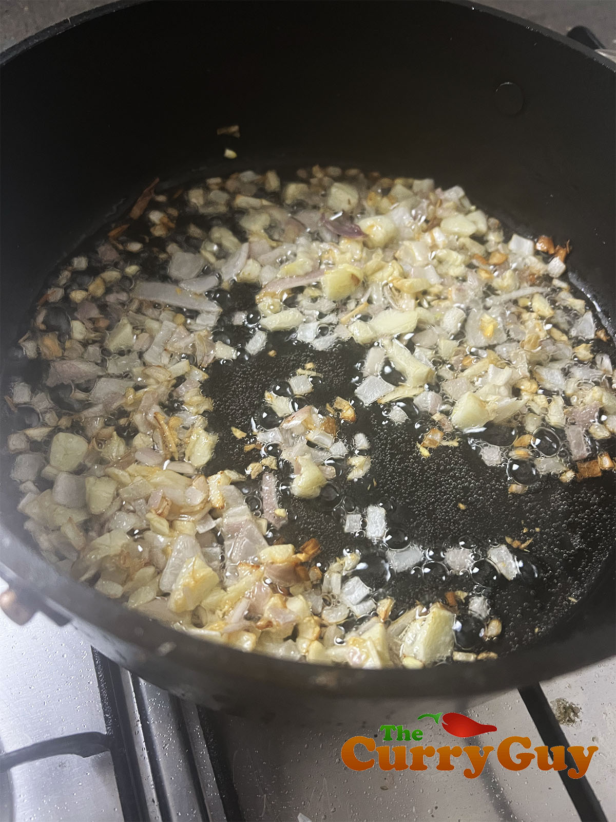 Frying the shallots, garlic and chillies.