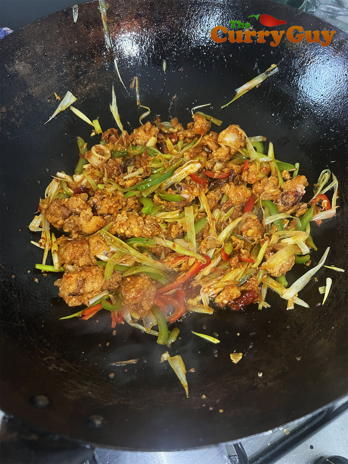 Coating the calamari in the sauce.