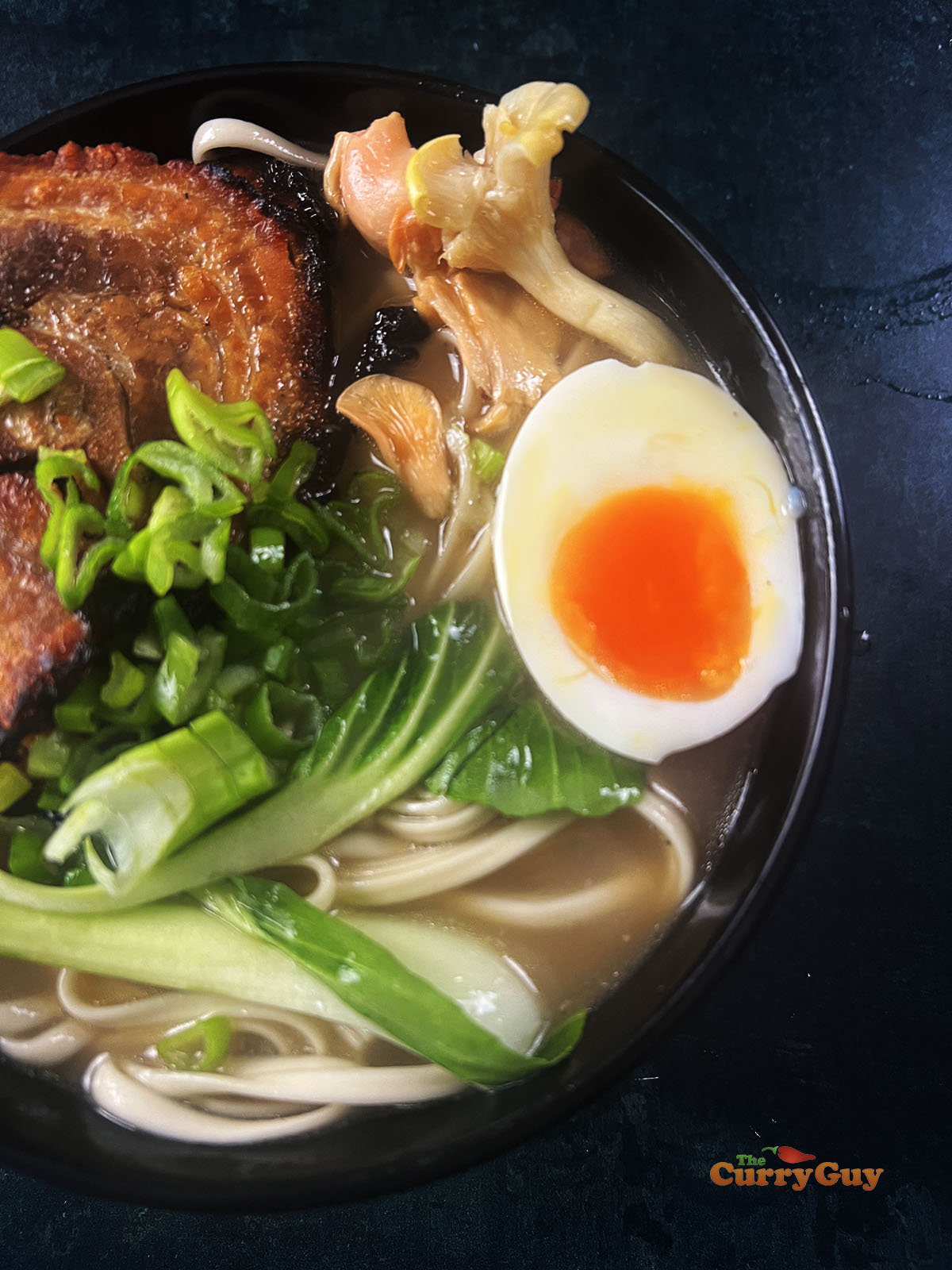 ramen garnished with chashu pork, boiled egg and veggies.