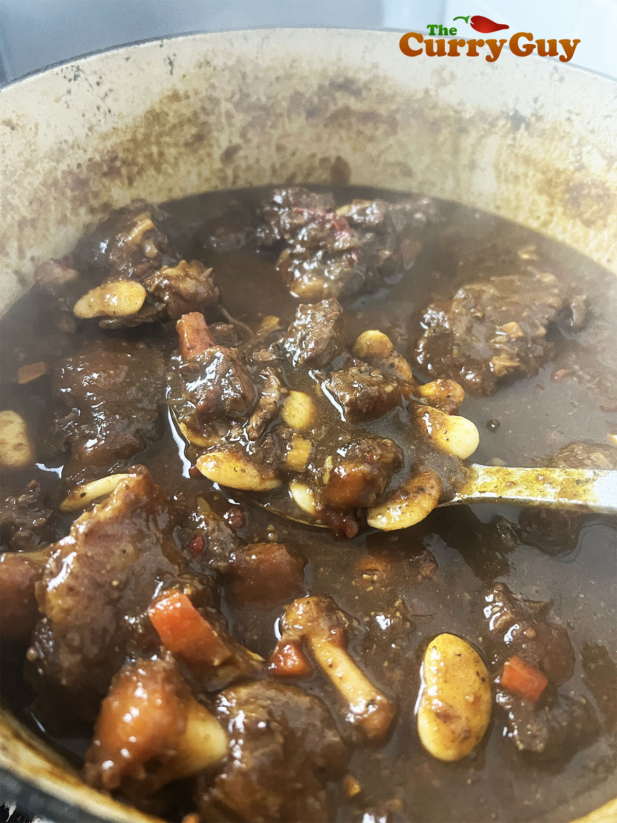 Simmering the Jamaican oxtail stew.