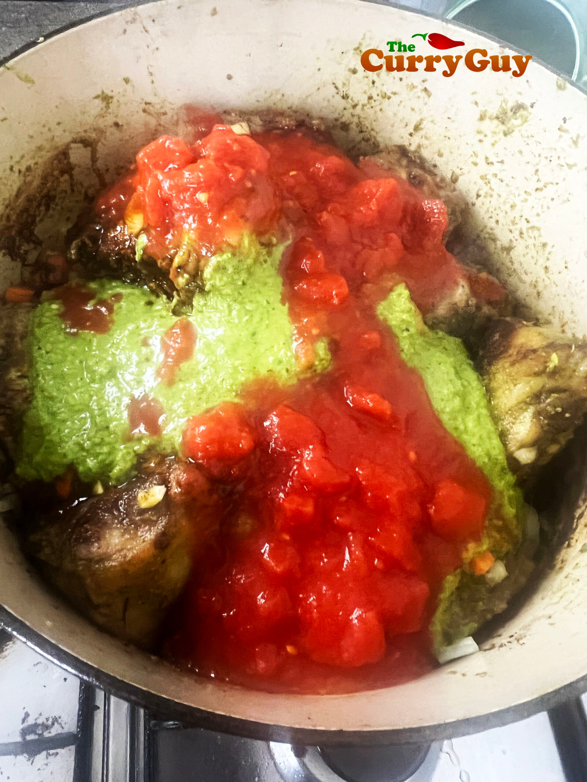 Adding the stew ingredients to the pan.