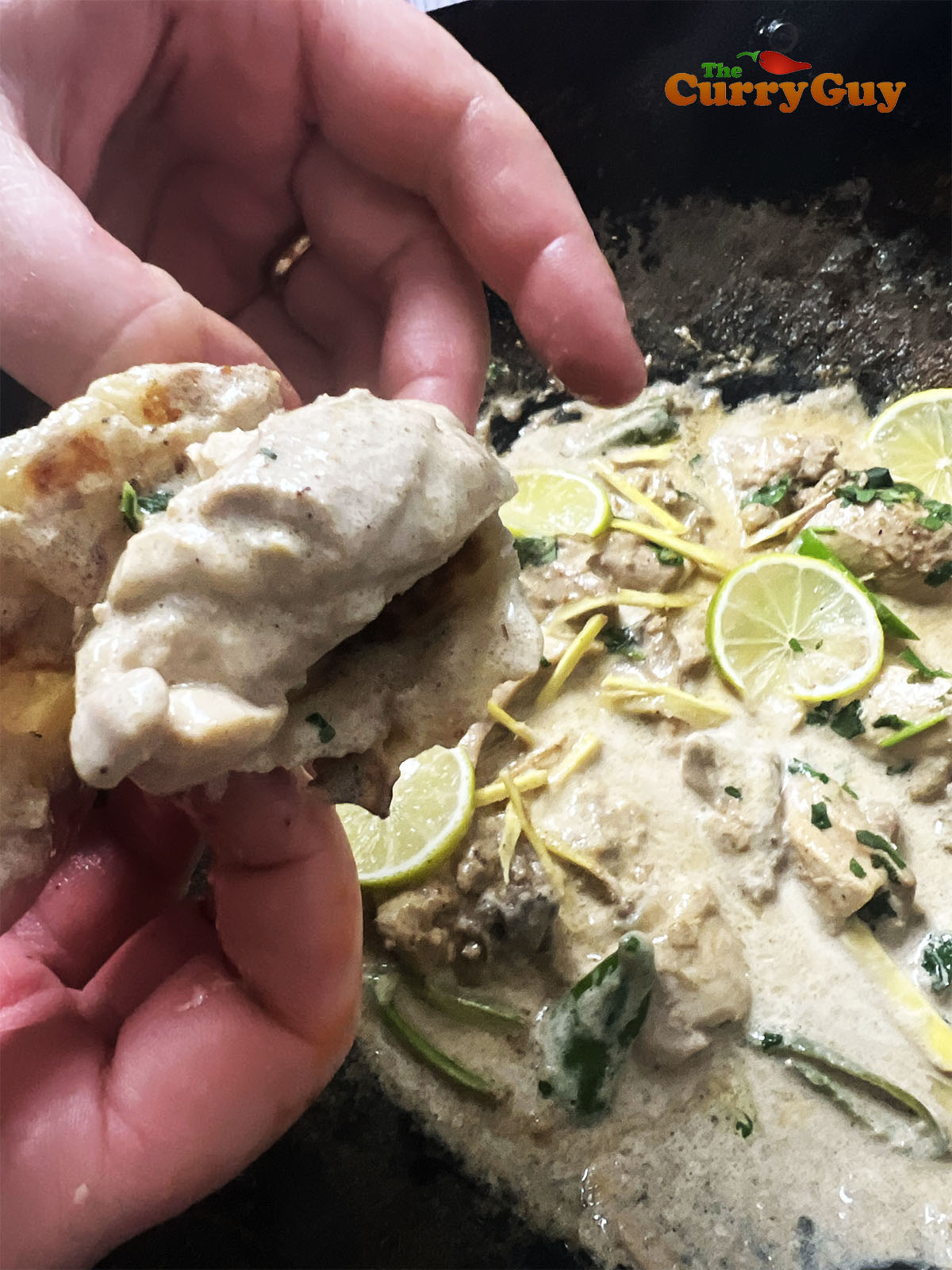 holding chicken with a chapatti