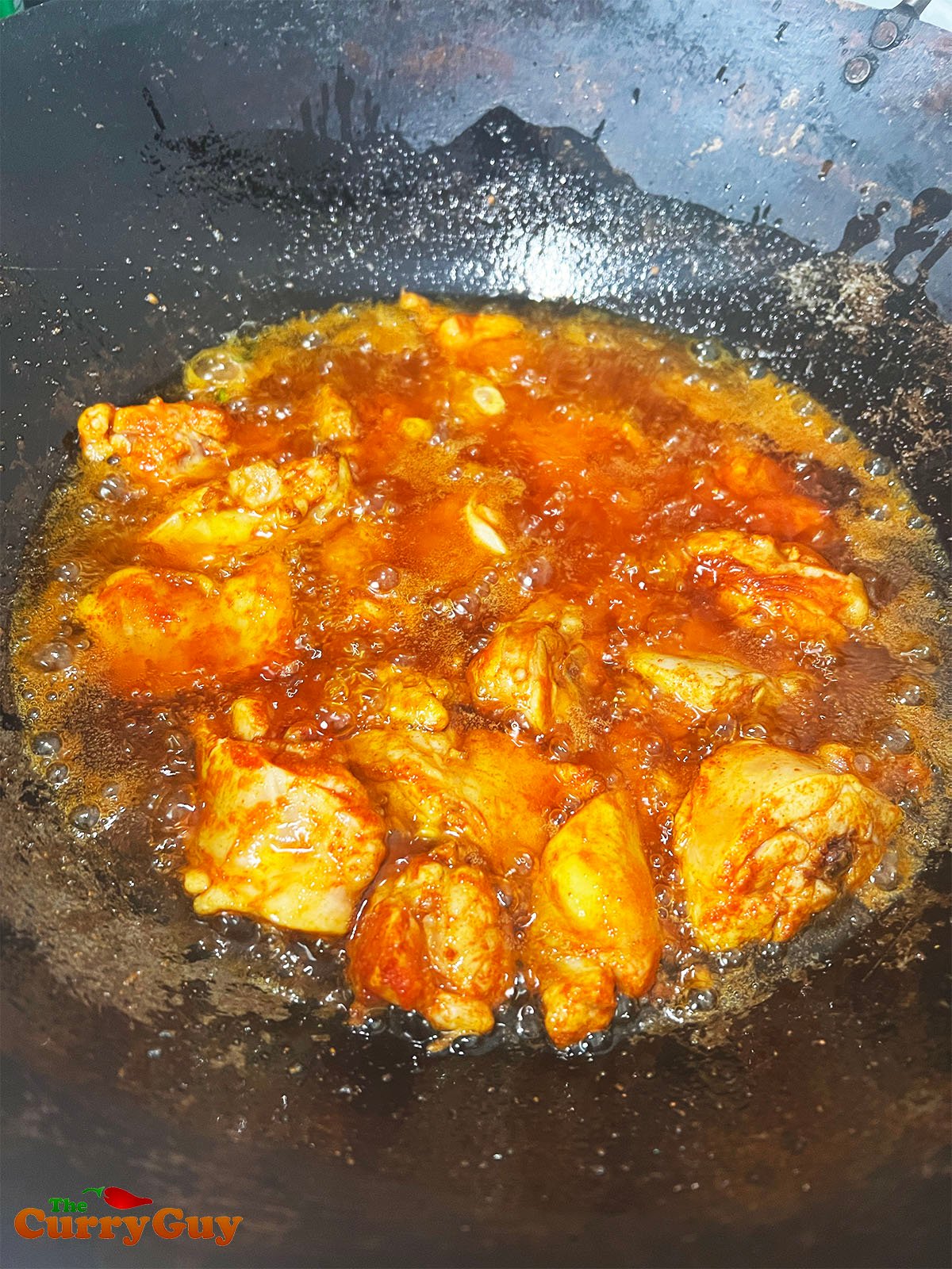 Frying the chicken in oil.