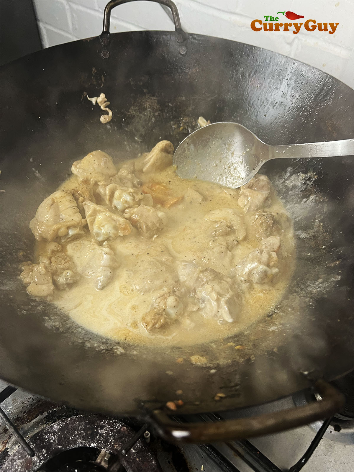 Stirring the yoghurt into the sauce