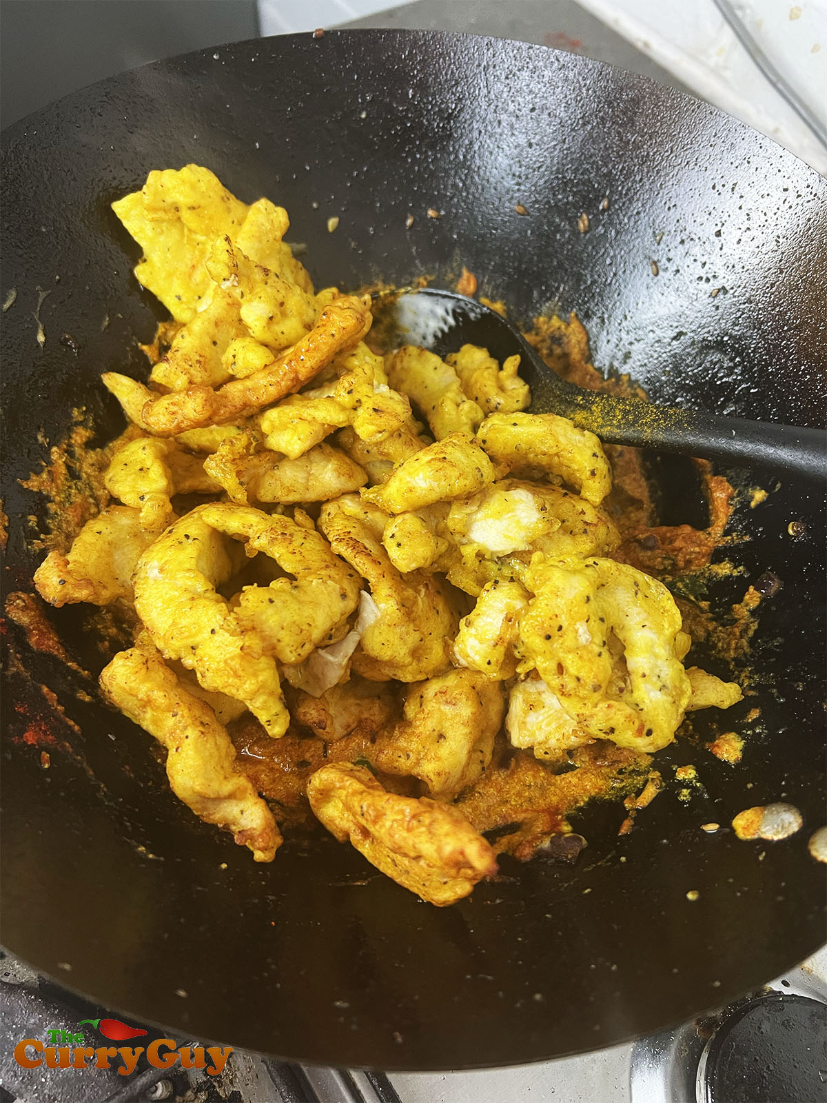 Adding the fried chicken to the sauce.