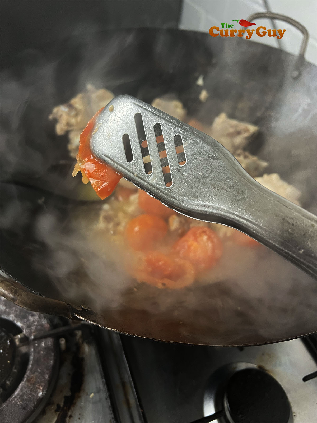 Removing the tomato skin from the cooked tomatoes.