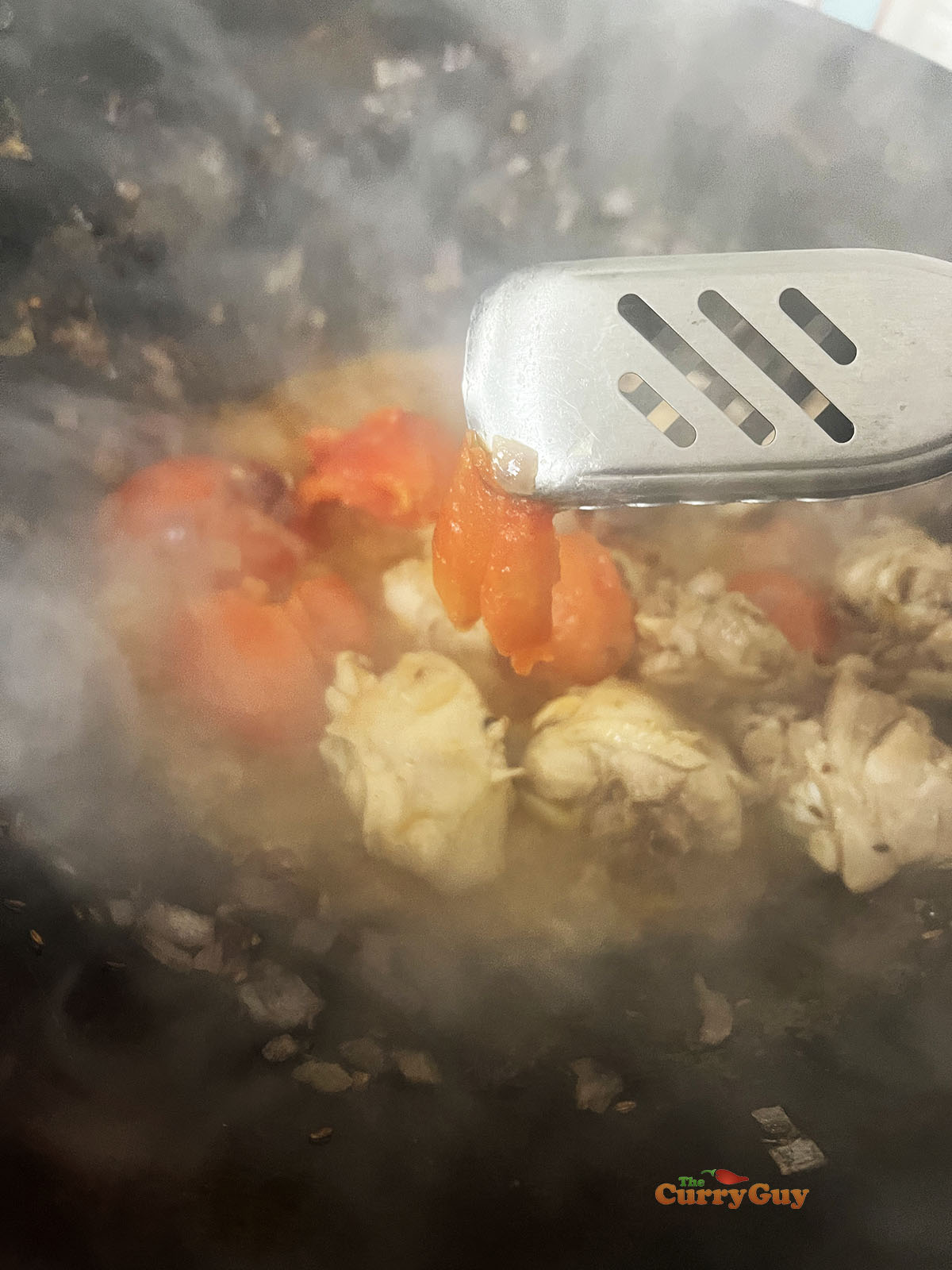 Removing the tomato skins from the tomatoes.