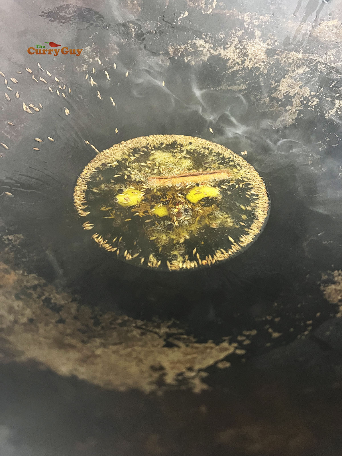 Infusing the whole spices in the ghee.