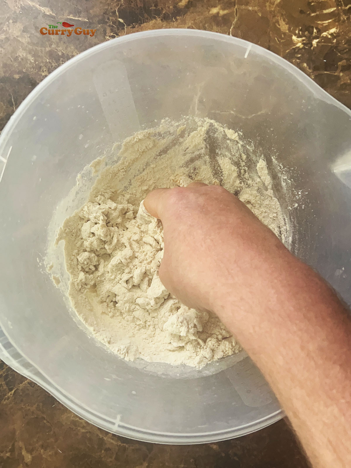 Adding water to the flour and salt