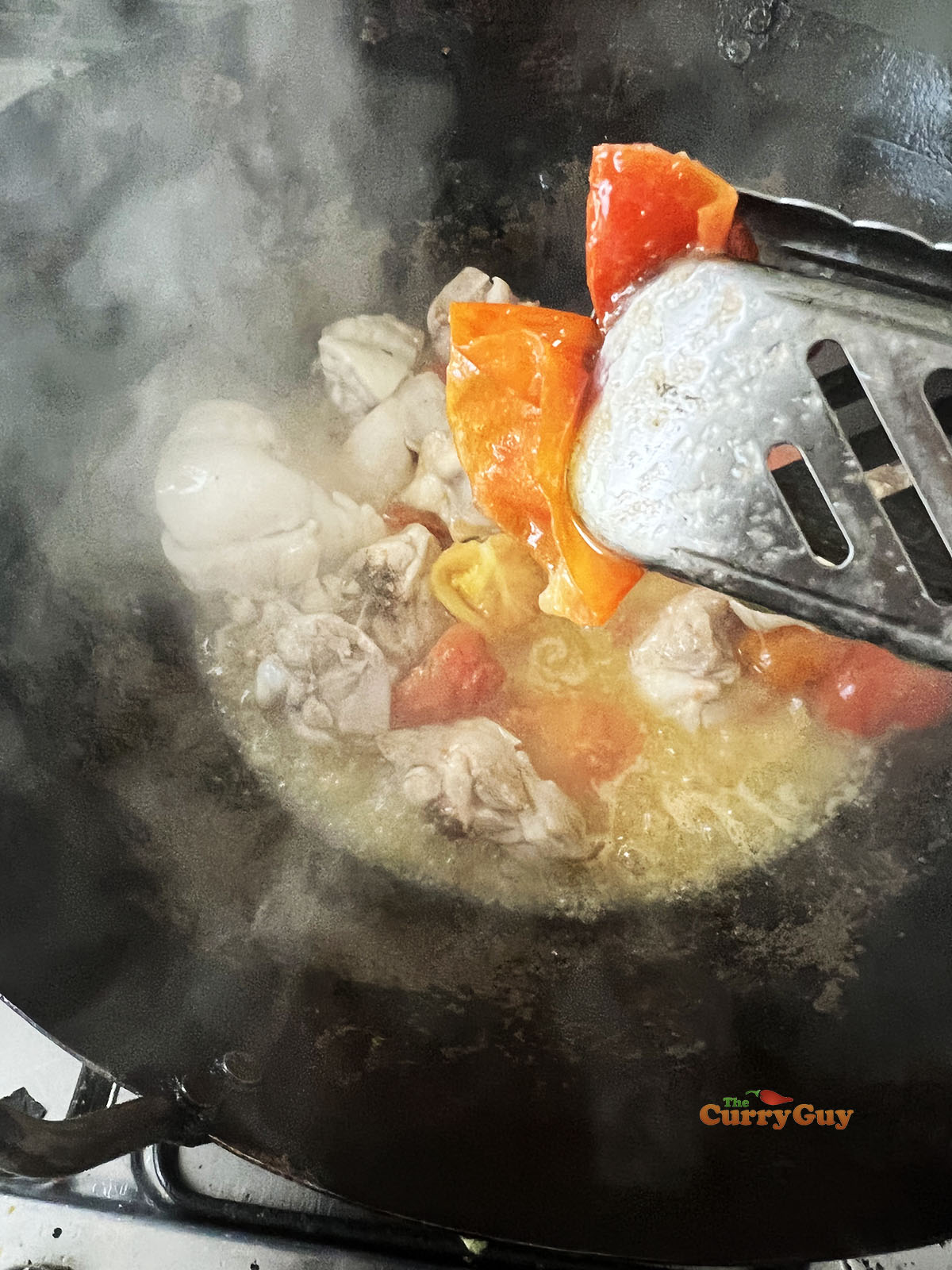 Peeling the skins off the tomatoes.