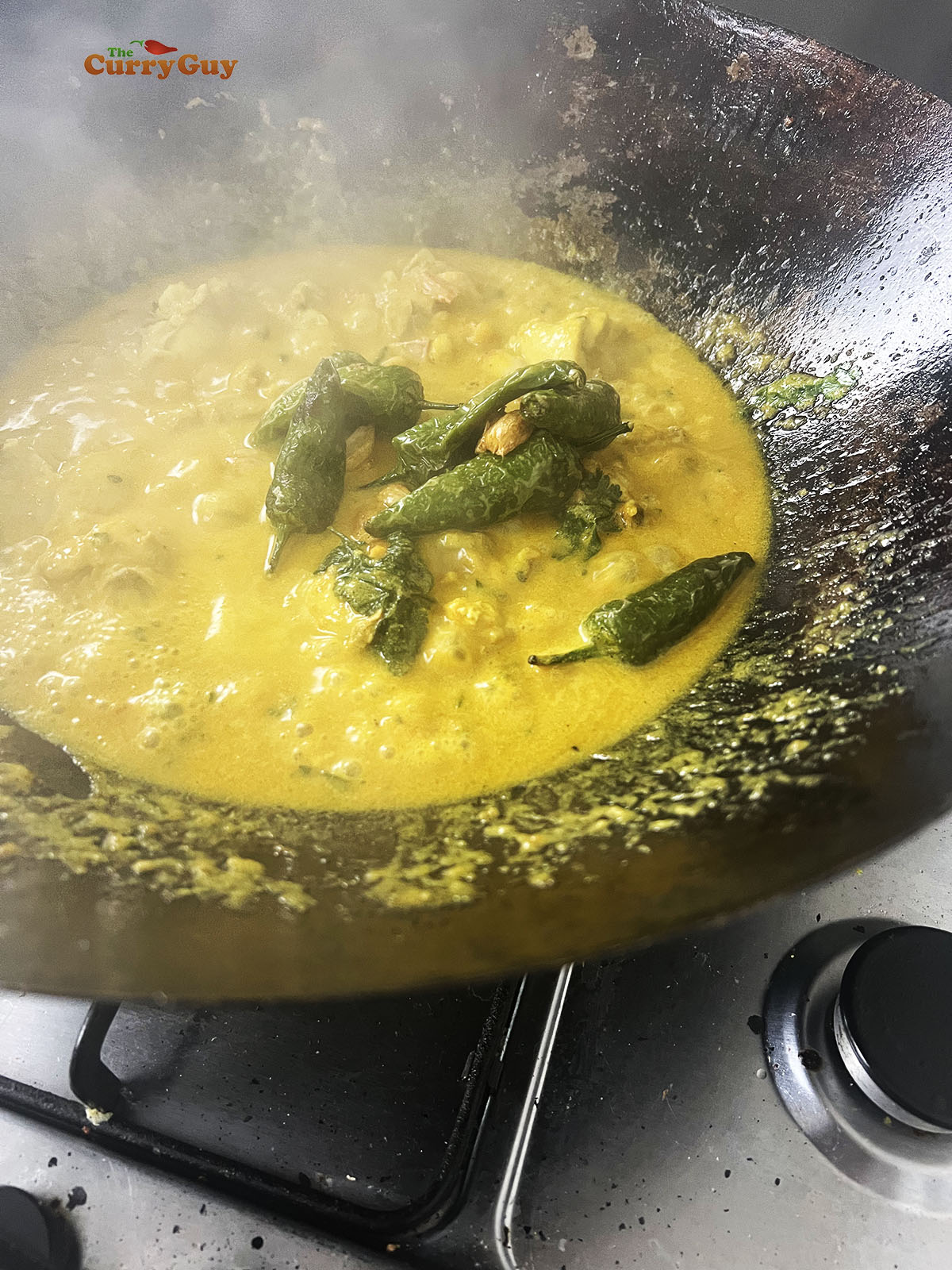 Adding the fried chillies and garlic to the pan