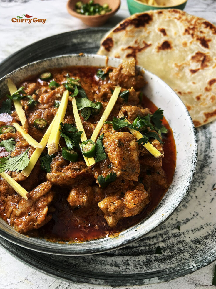 Garnishing the curry with ginger, coriander (cilantro) and chillies.