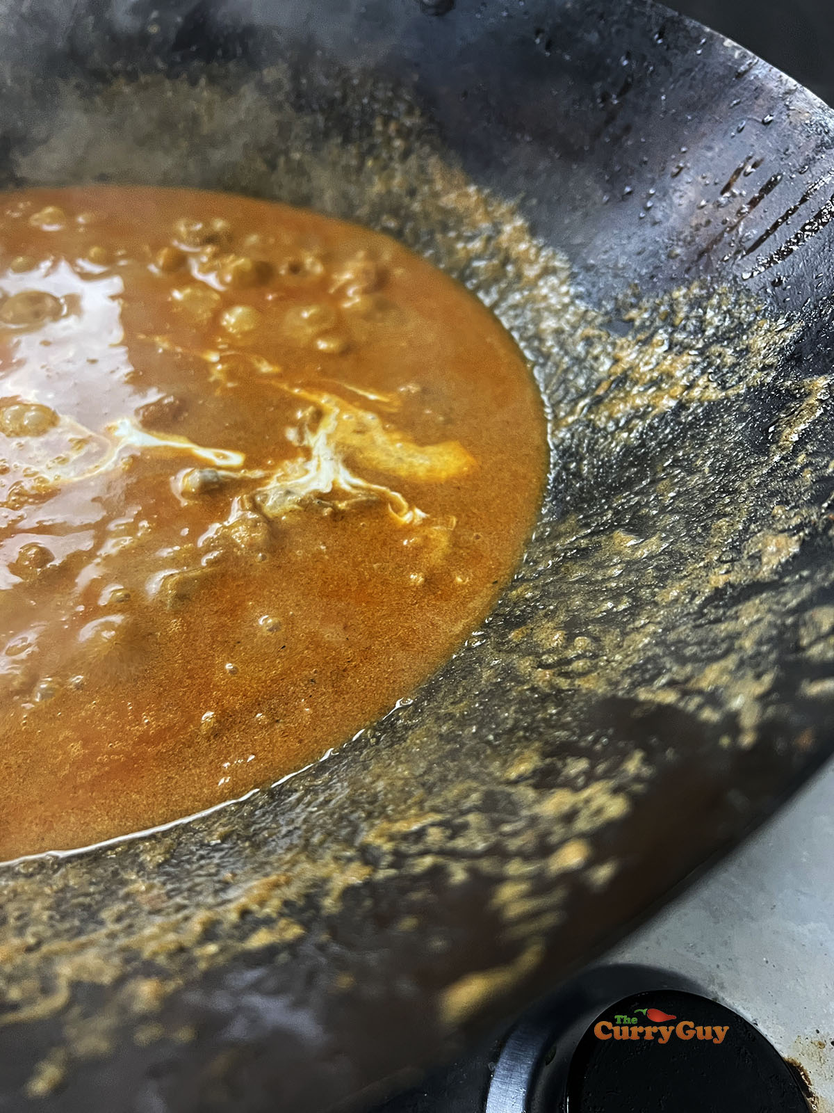 Adding cream to the sauce.