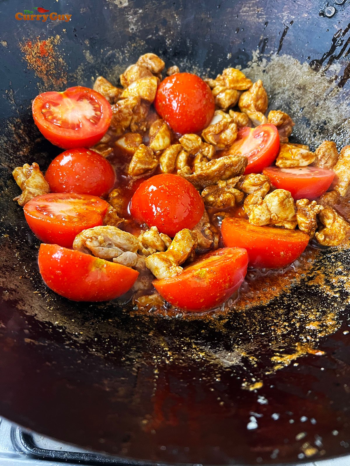 Adding the ground spices and tomatoes