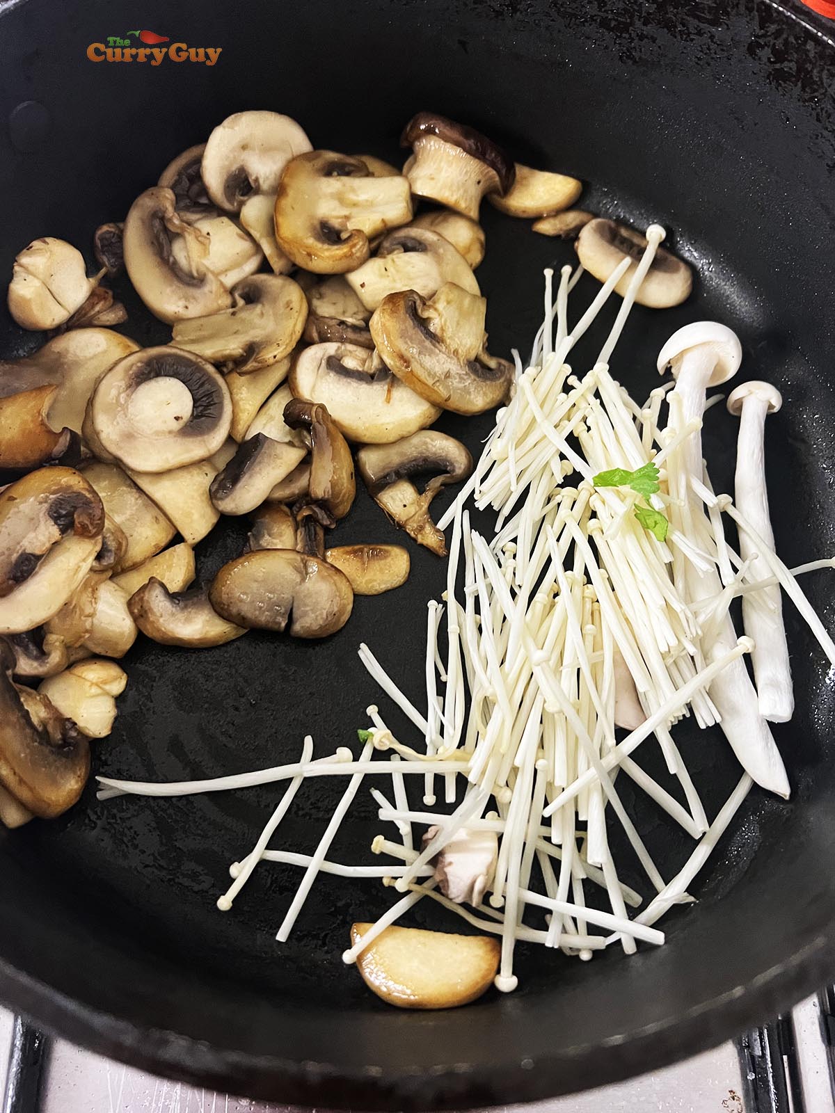 Frying the mushrooms in oil in a pan.