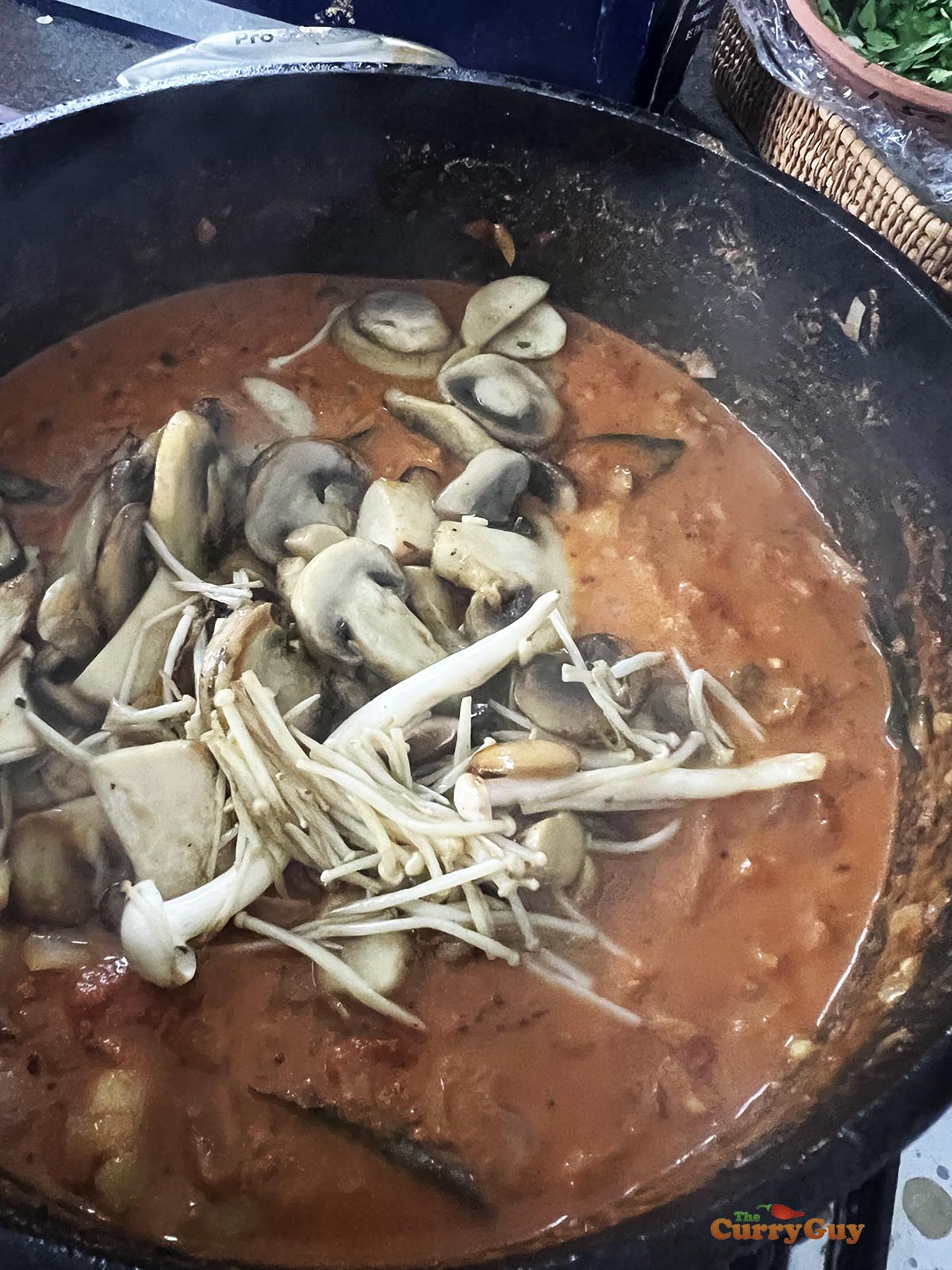 Returning the mushrooms to the pan.