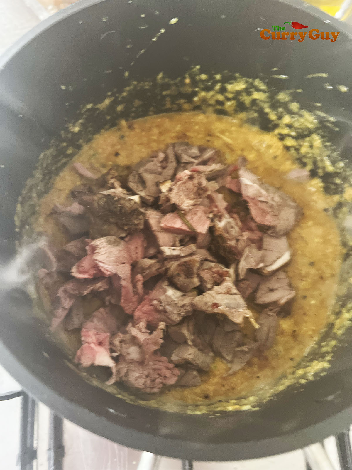 Stirring in the chopped tomatoes and meat. 