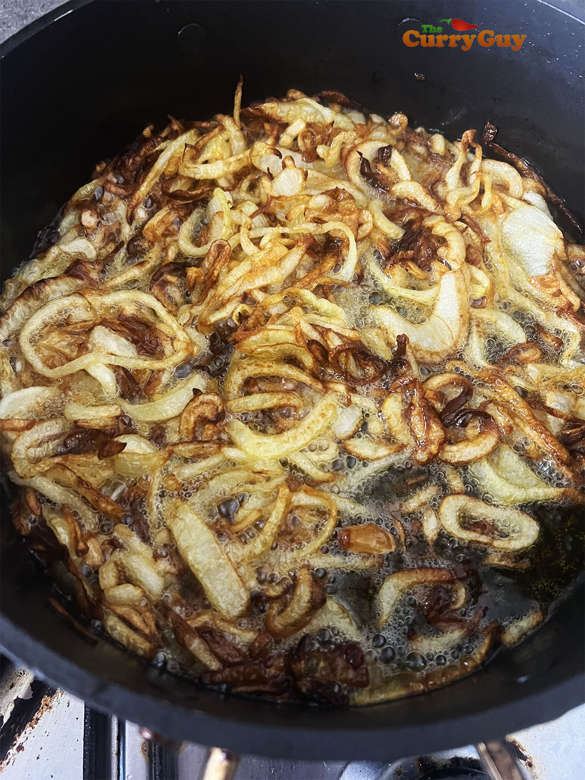Frying sliced onions in ghee.