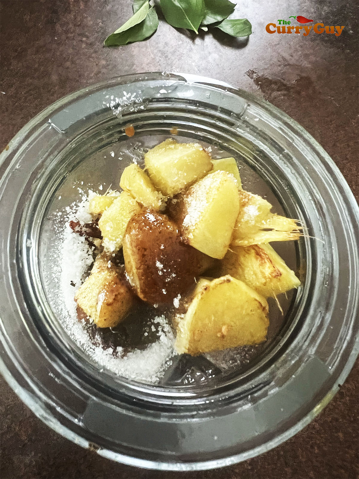 Adding the fried ginger to the blender with the chillies and lentils.