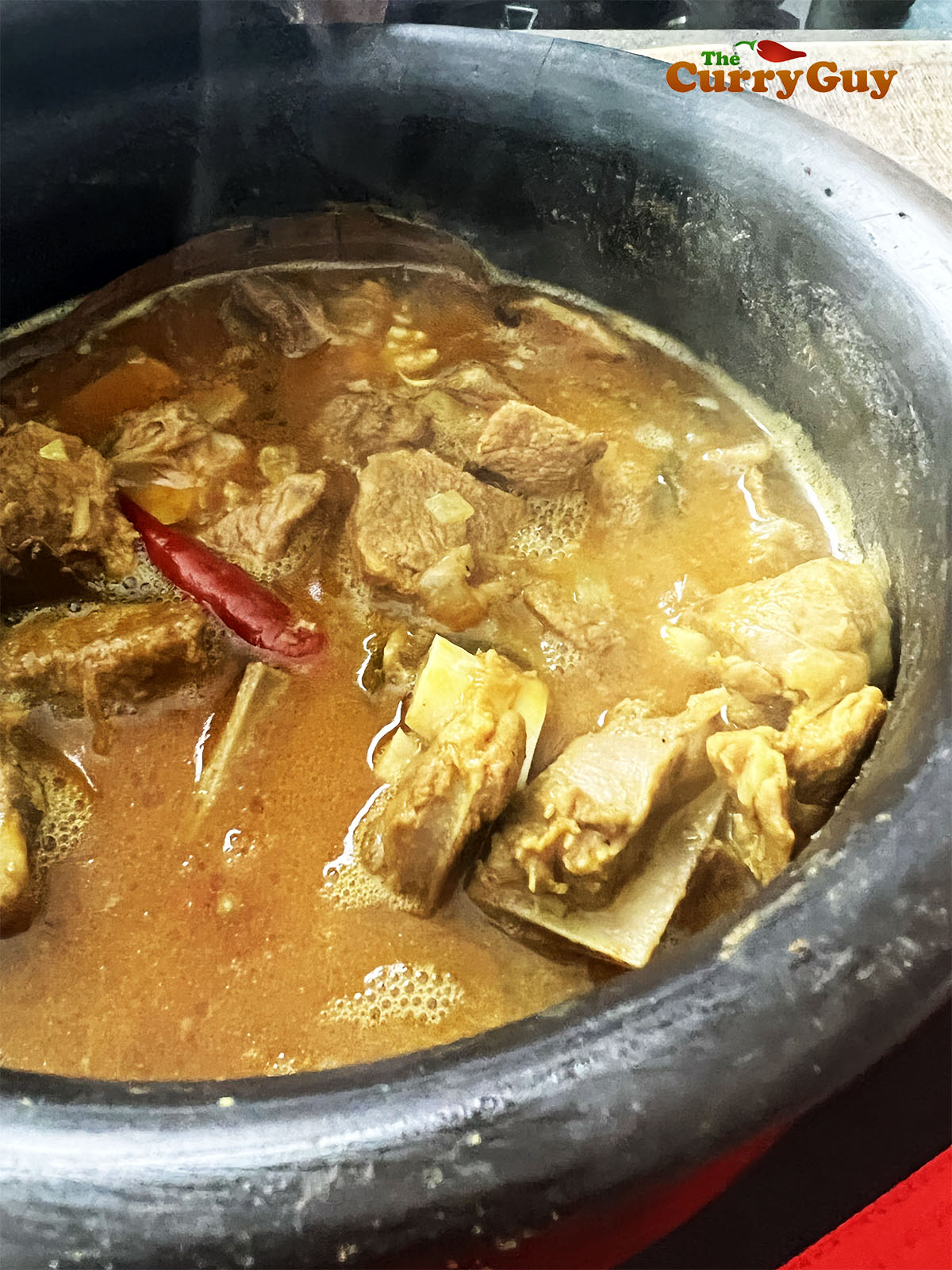 Simmering the curry to thicken the sauce