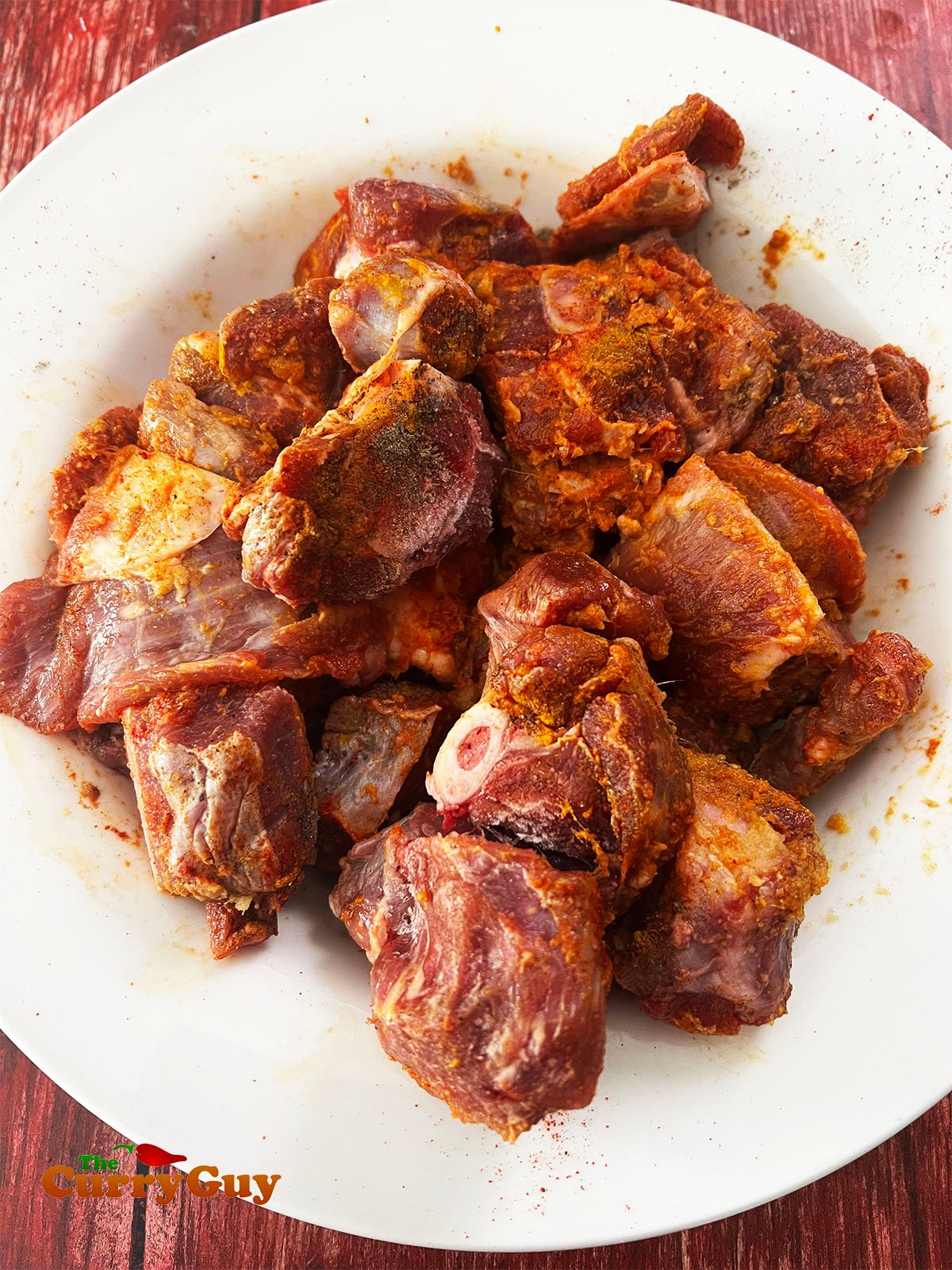 Adding the marinade to the mutton