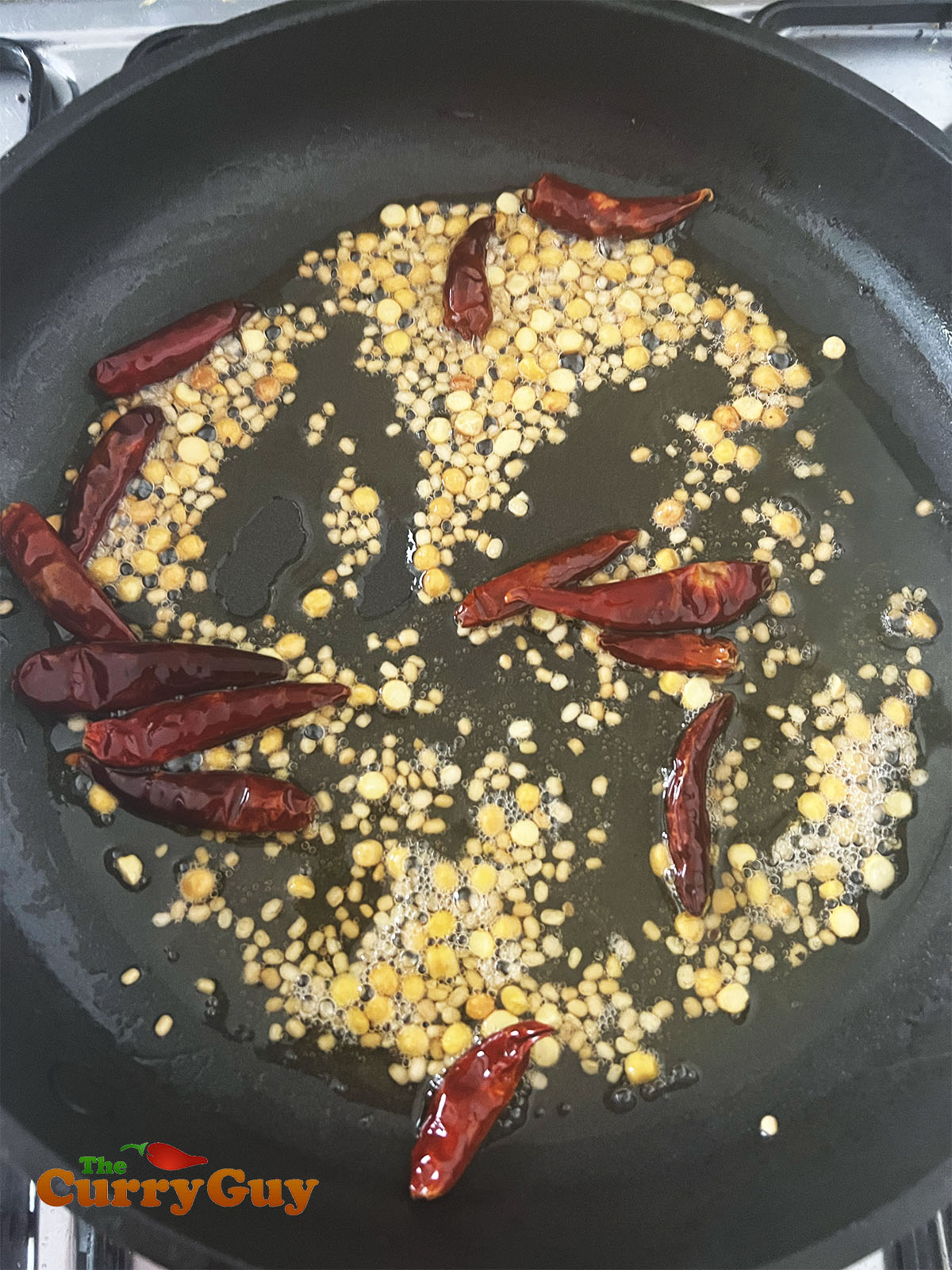 Frying the lentils and dry chillies.
