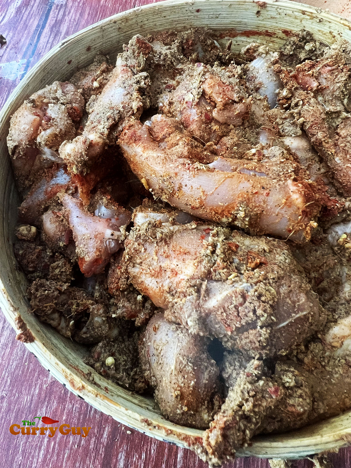 Rubbing the spice paste into the chicken