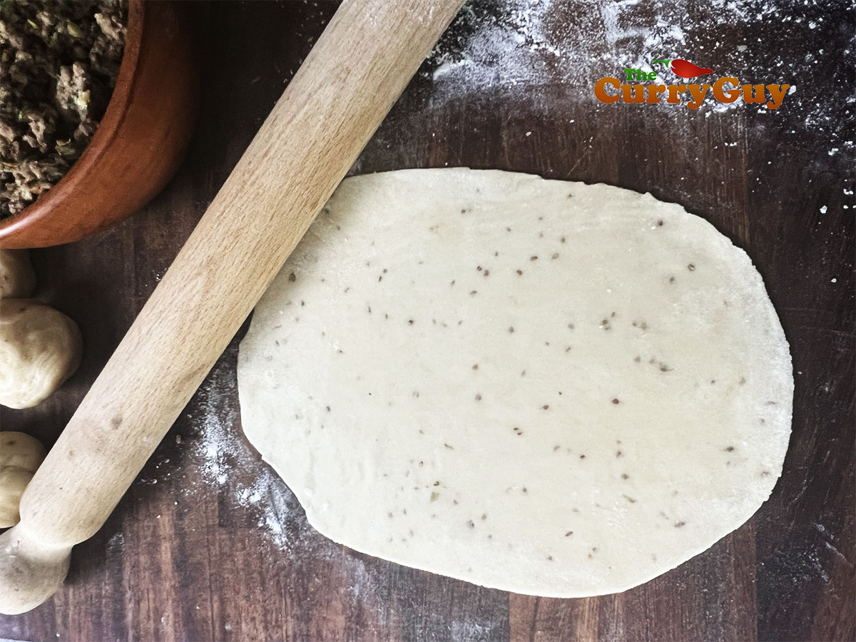 Rolling out the samosa pastry.