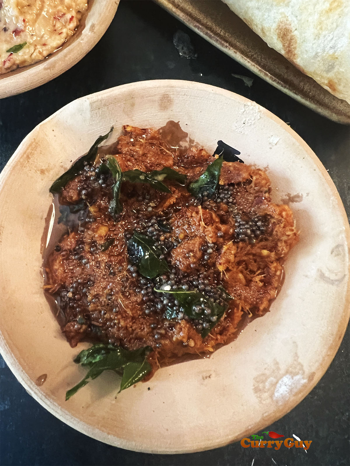 Pouring the seasoned oil over the ginger chutney