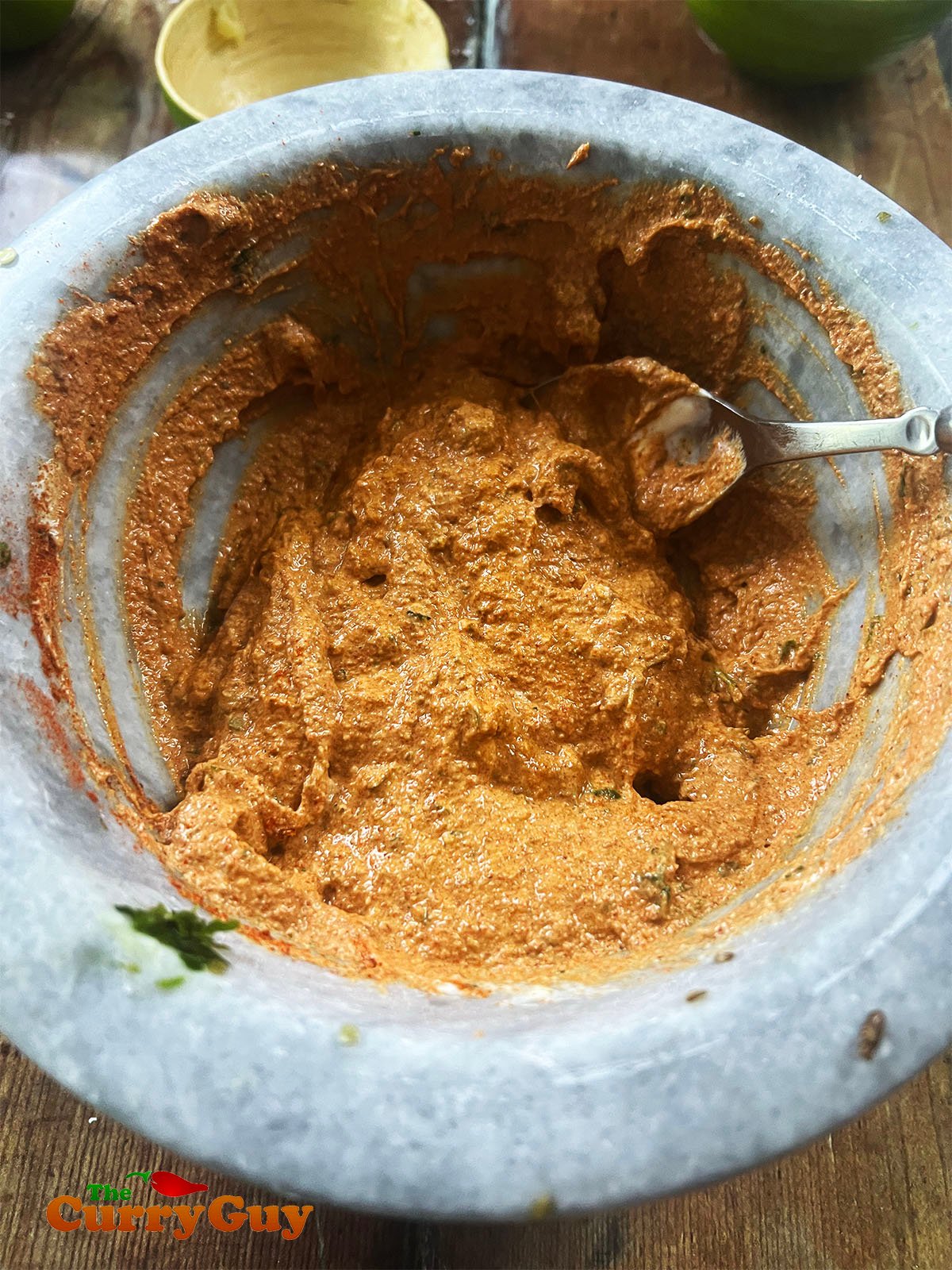 Adding the remaining marinade ingredients to the chillies and coriander (cilantro).