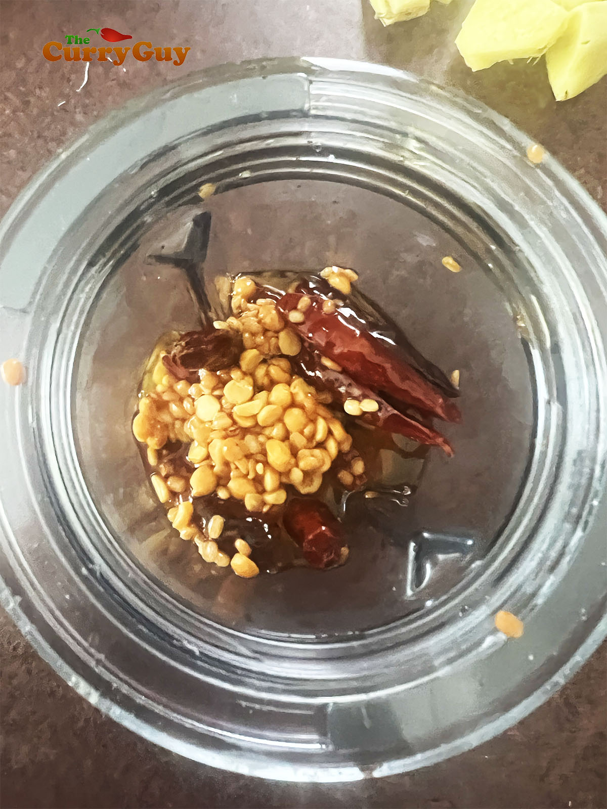 Placing the dried chillies and fries lentils in a blender.