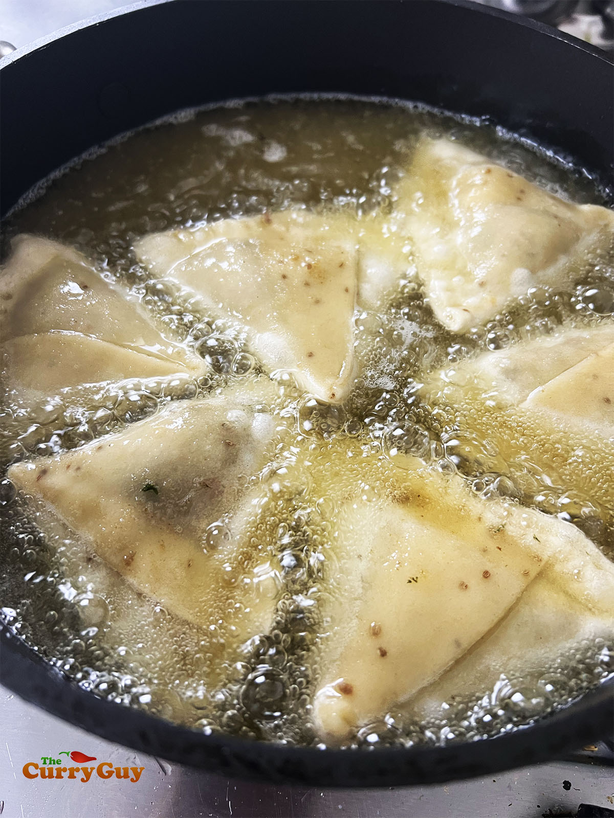 Frying the samosas.