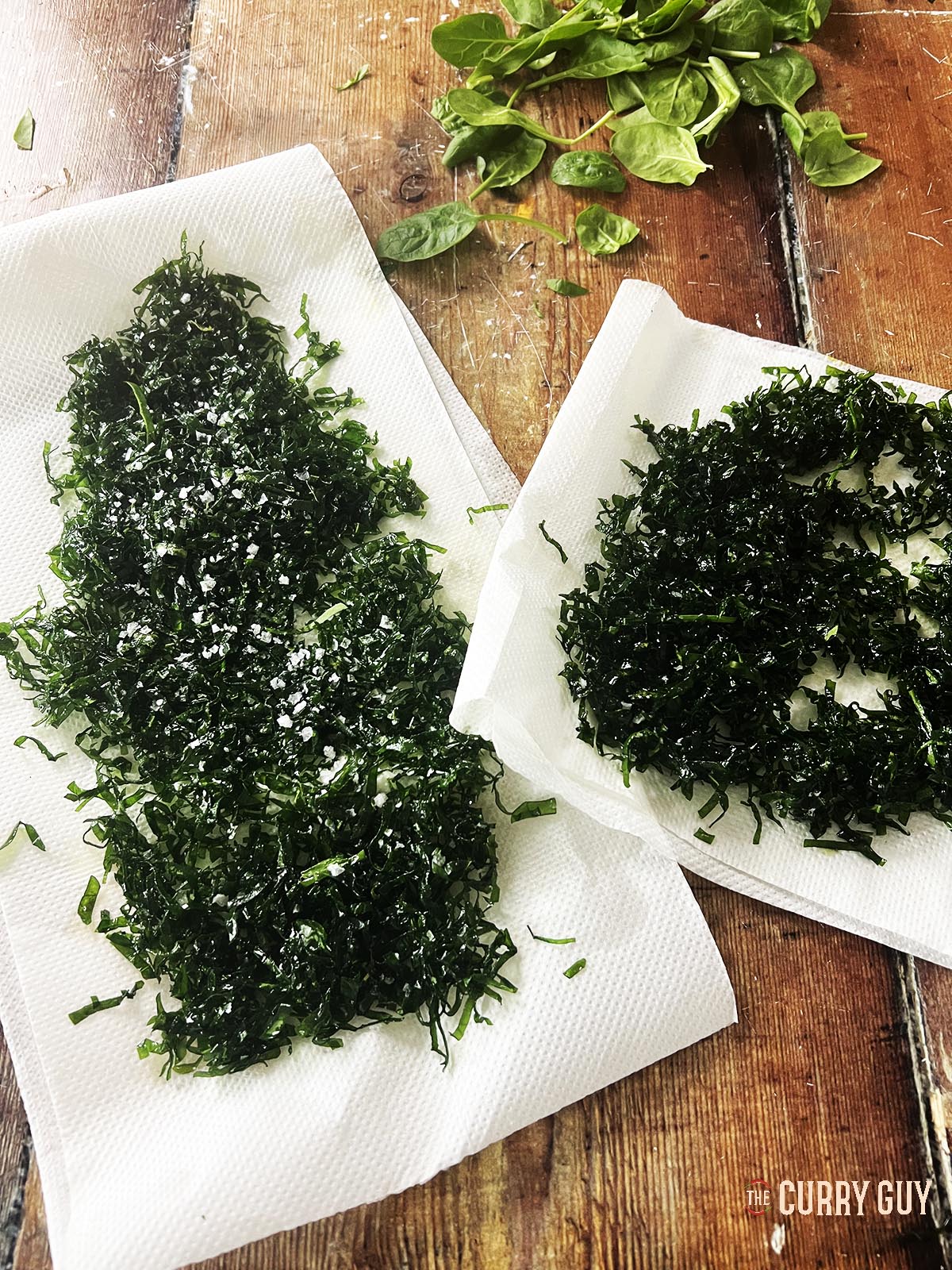 The finished fried spinach drying in paper towels.